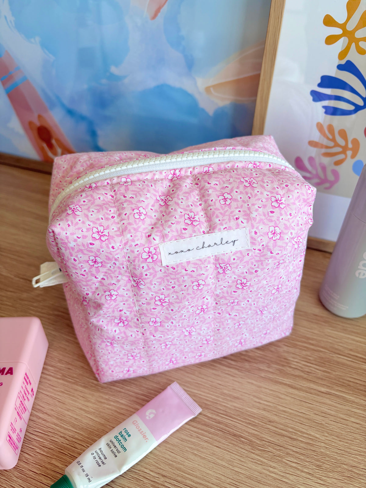 Pink glitter makeup bag with Hawaiian print, top zipper and front patch label