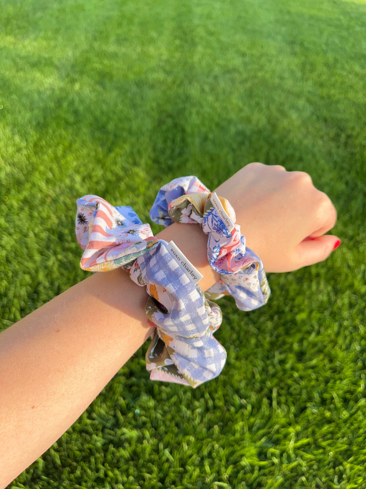 Colorful picnic cotton scrunchie on wrist, blue gingham with patchwork print