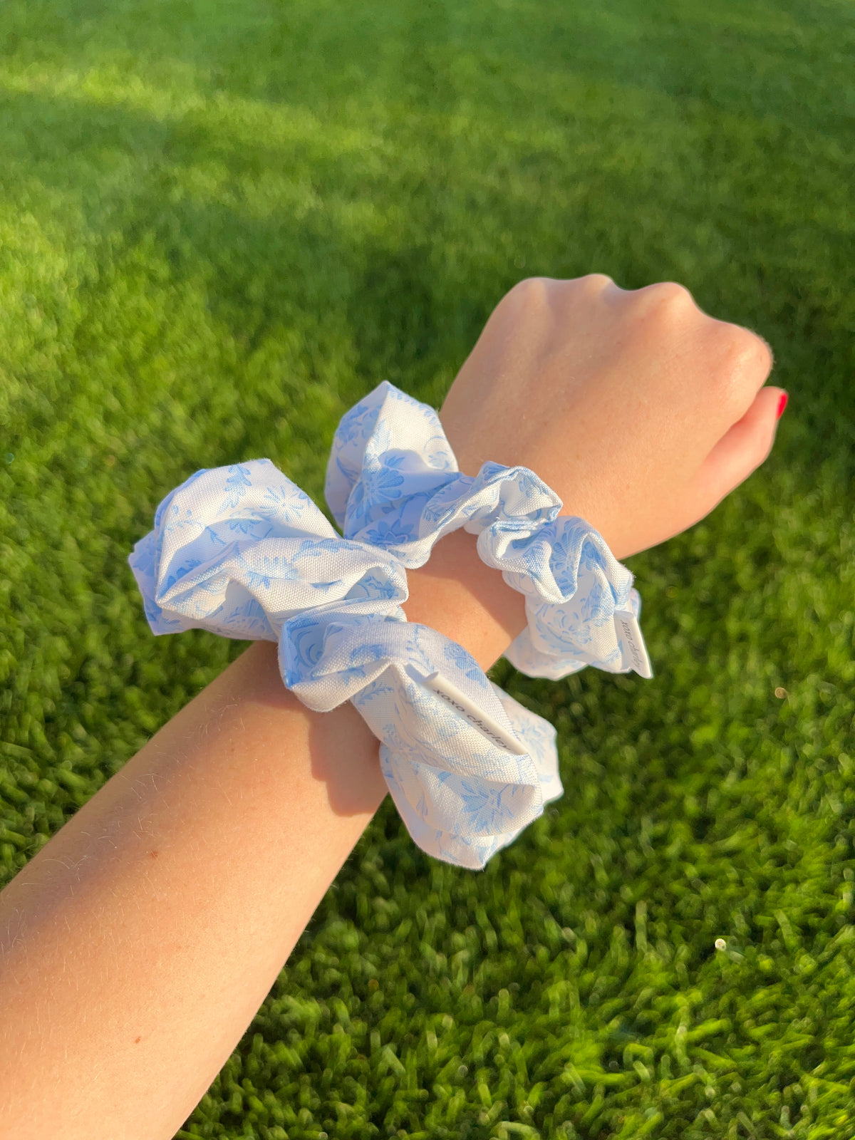Blue cotton scrunchie with gathered ruffles on wrist