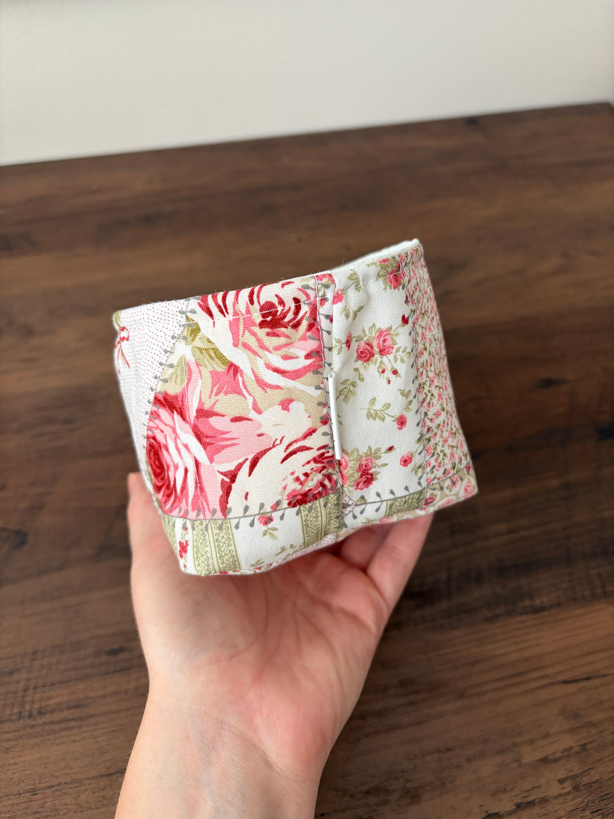 Small fabric bowl side view with red rose patchwork on cream