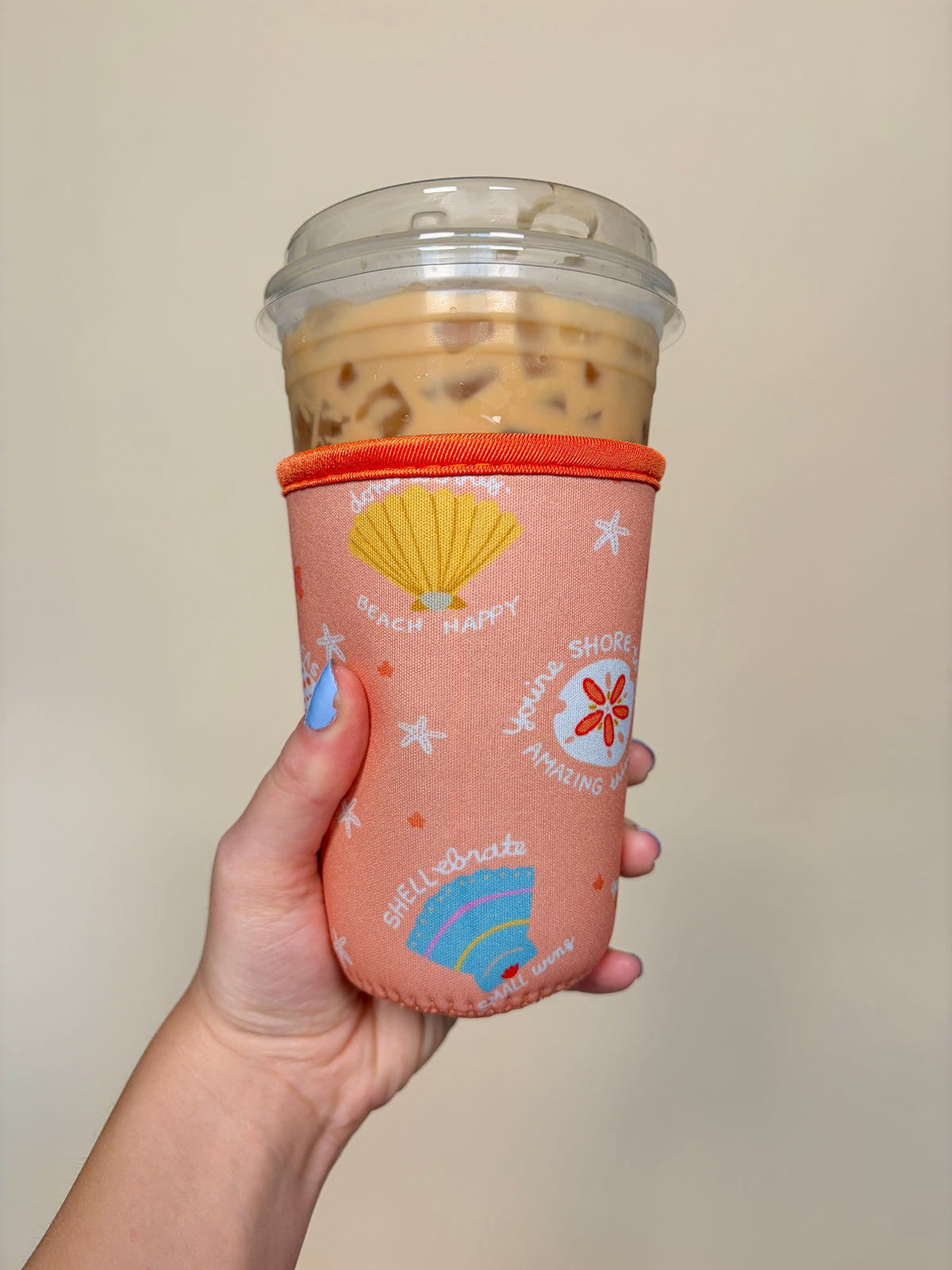 Orange small cup sleeve with beach-happy text, seashell and starfish prints, elastic band top