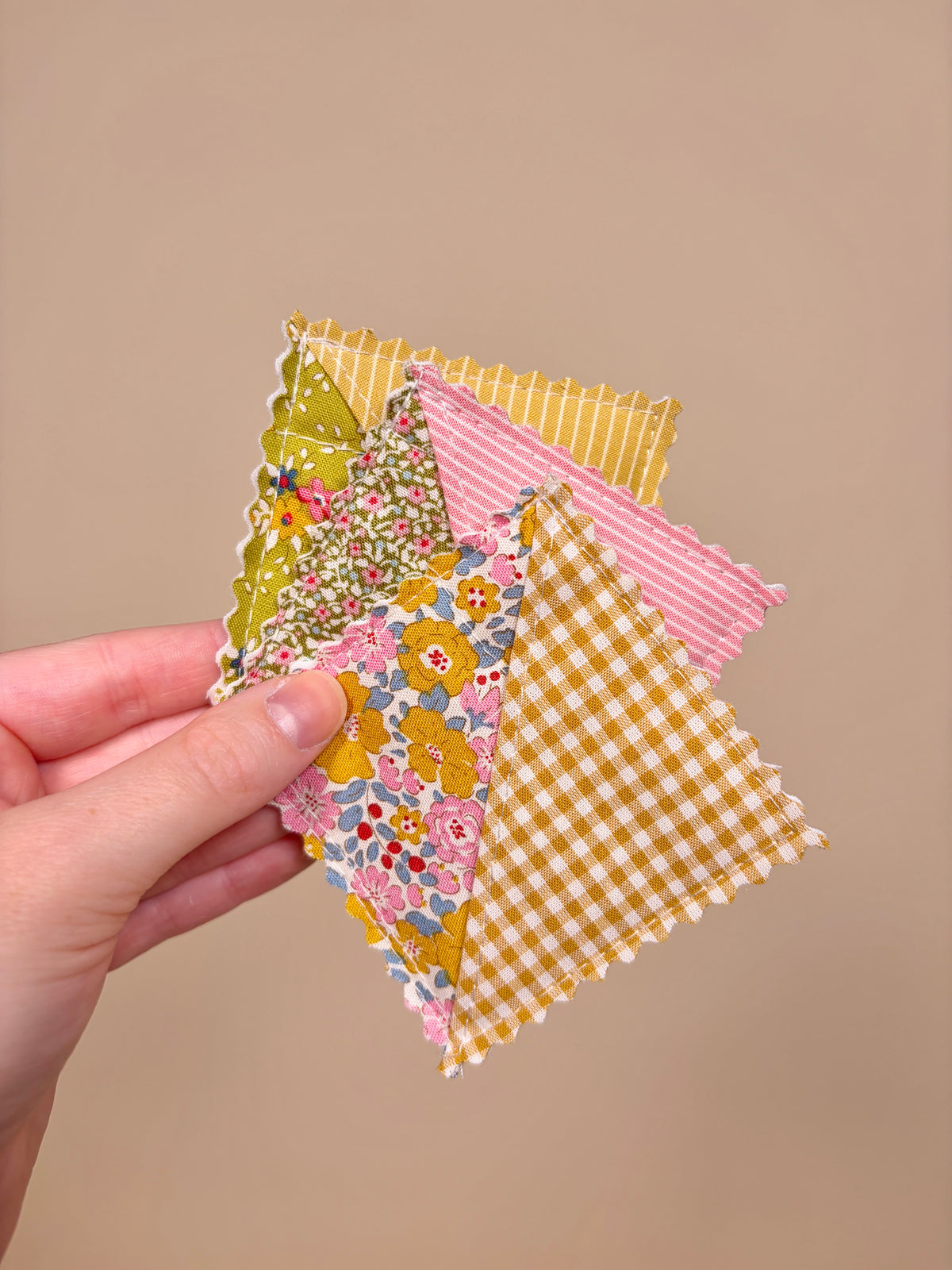 Multicolor fabric corner bookmarks with floral, gingham, and striped panels, scalloped edges