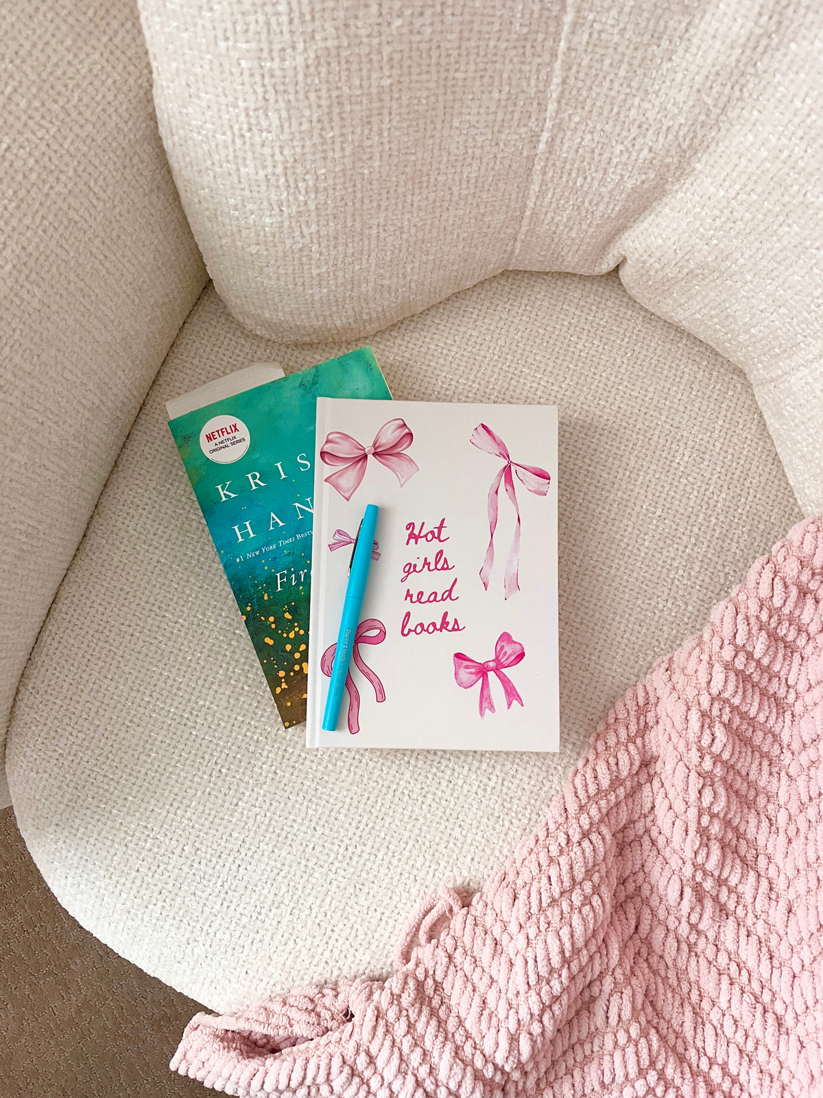 Reading journal with pink ribbon cover, plus another book-themed journal in green.