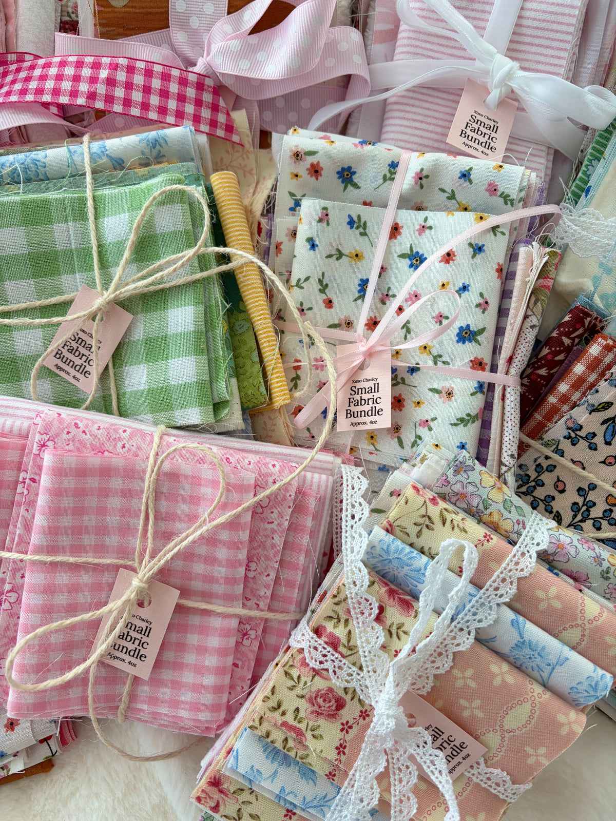 Small fabric bundle with green plaid, floral squares, and stitched lace-edged wraps