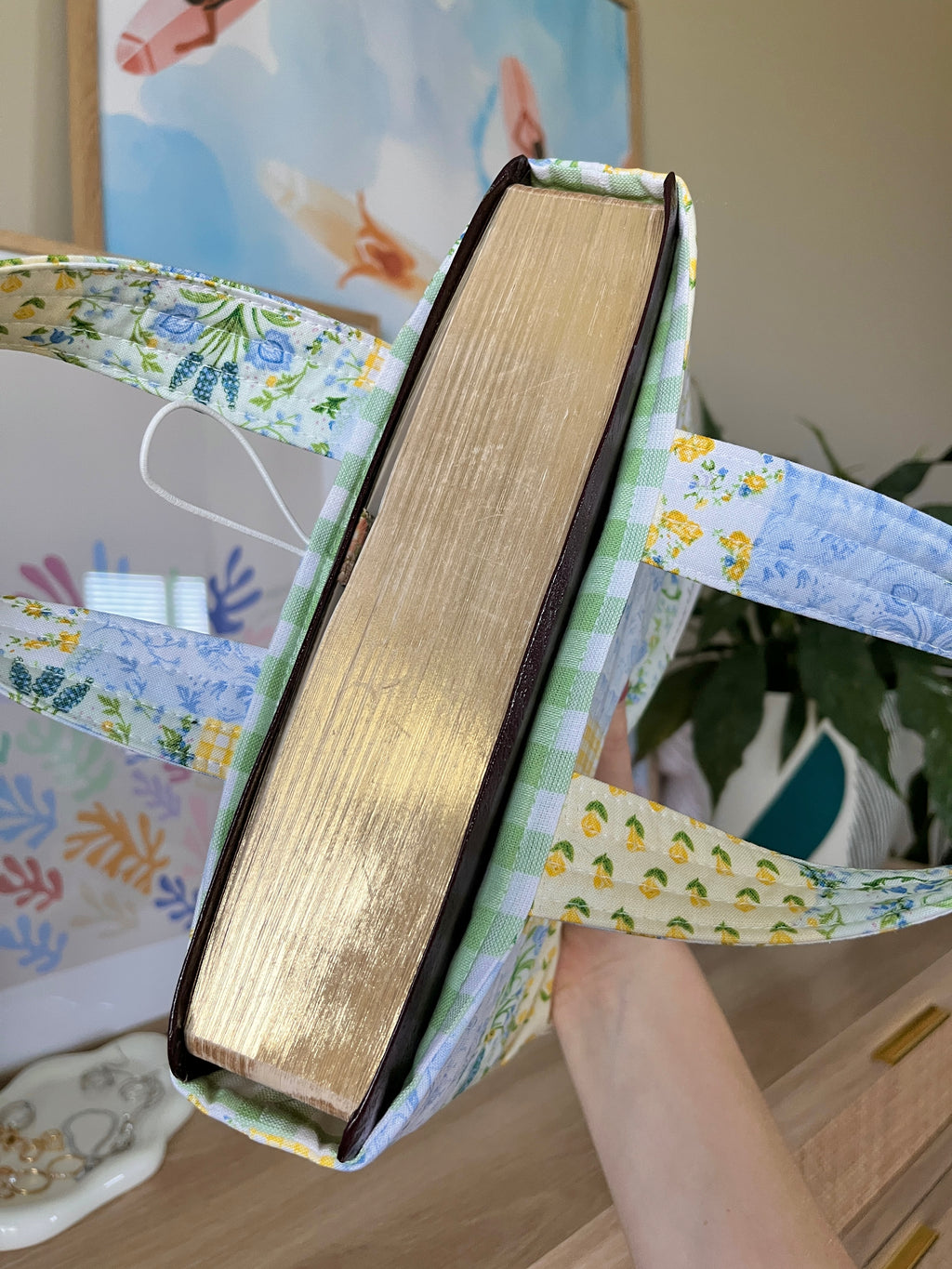 Bible tote holding an upright book insert, showing patchwork fabric lining