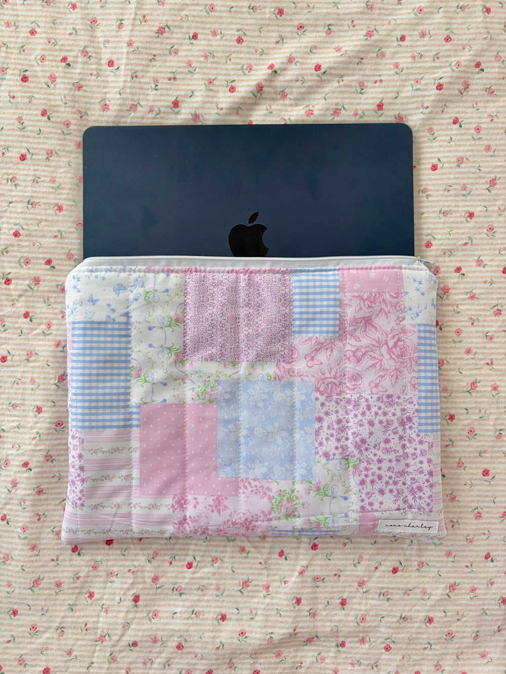 Patchwork laptop sleeve with pastel pink and blue quilted panel, open top with zipper