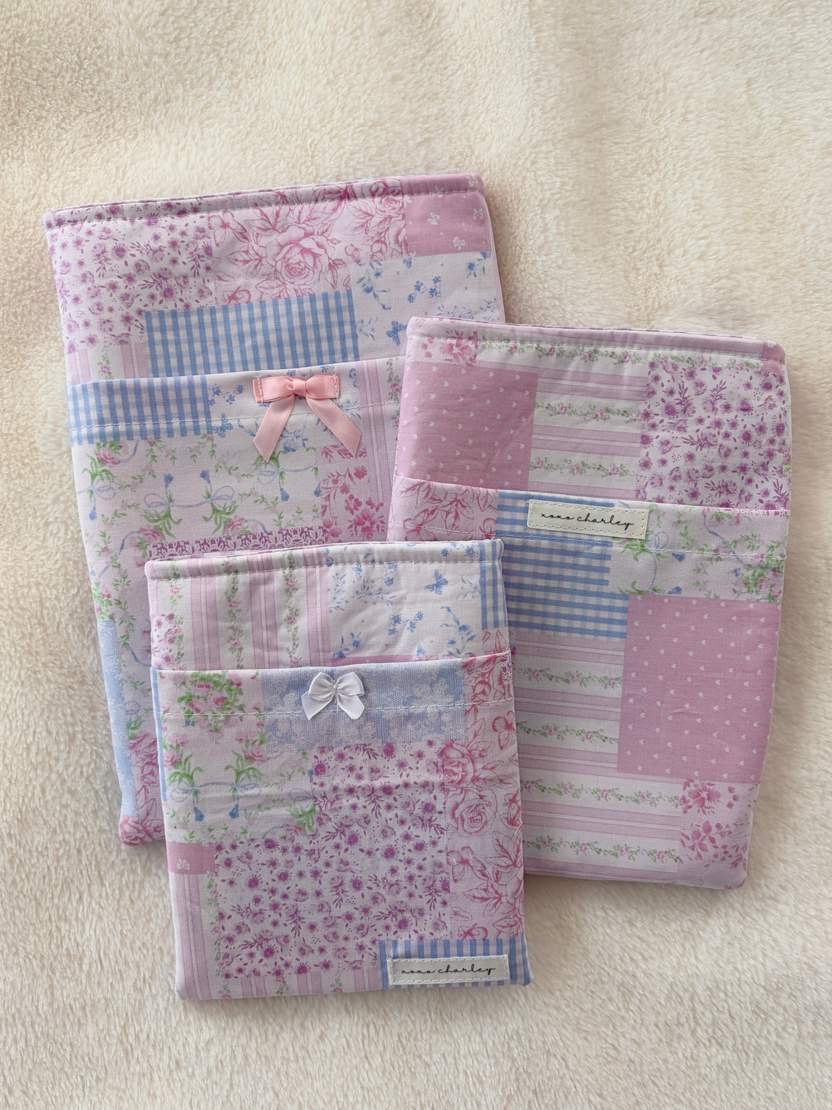 Pink patchwork e-reader/book sleeve with stitched bow front, fabric-lined pages