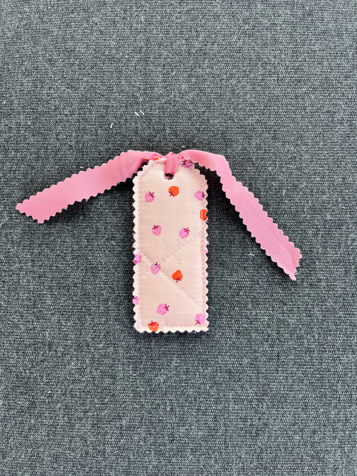 Blush pink ribbon gift tag with strawberry pattern, scalloped white card
