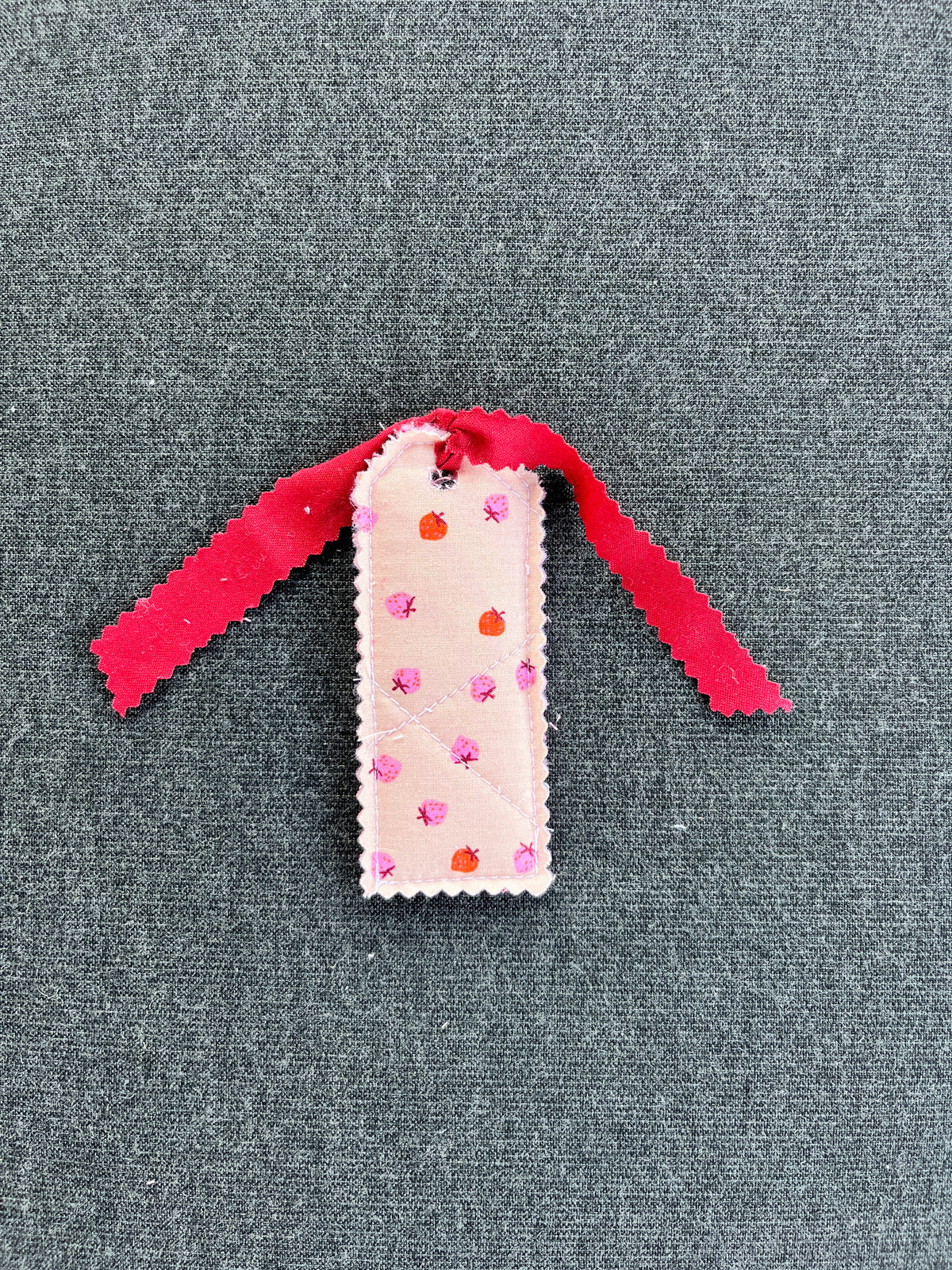 Maroon strawberry gift tag with white card and pink ribbon, scalloped top