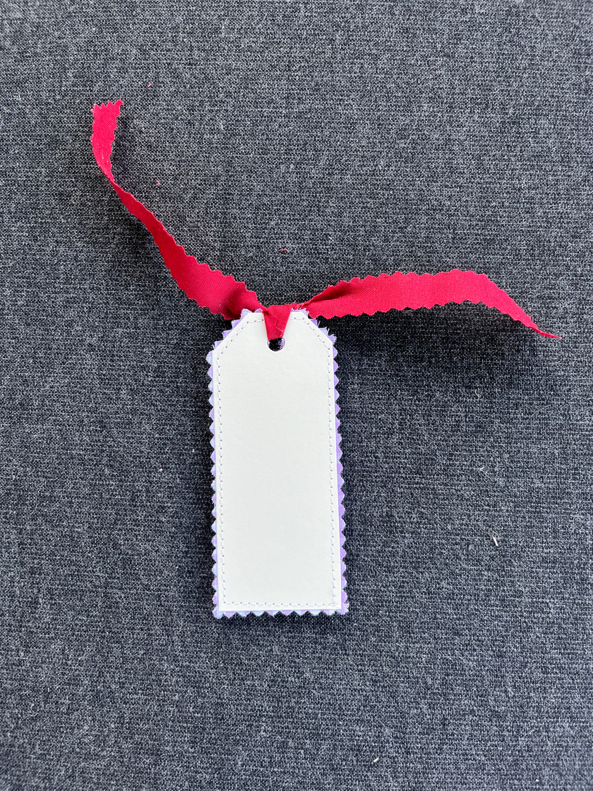 Scalloped white gift tag with pink ribbon loop