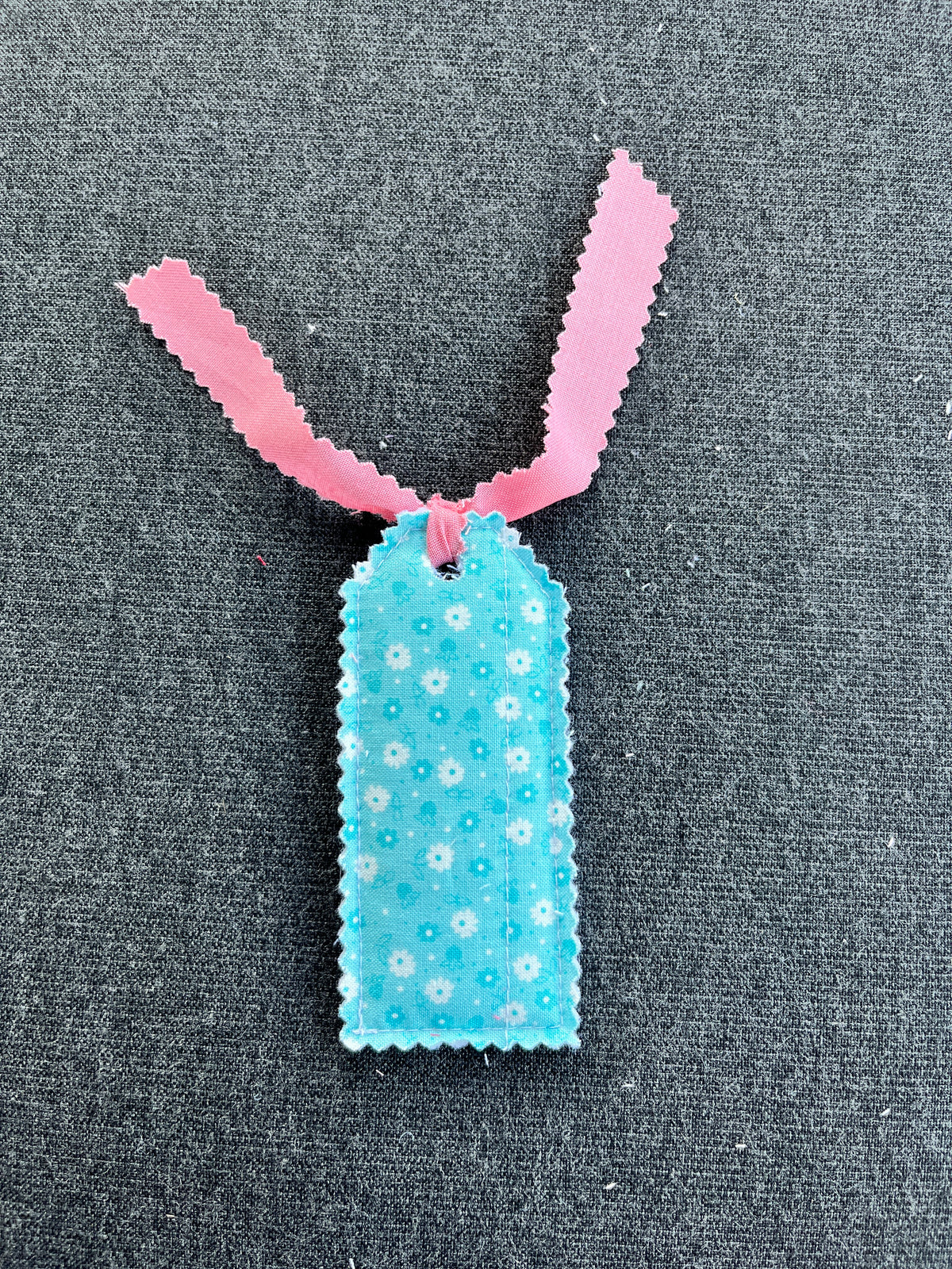 Blush pink and blue floral gift tag with bunny-ear top and blue ribbon loop