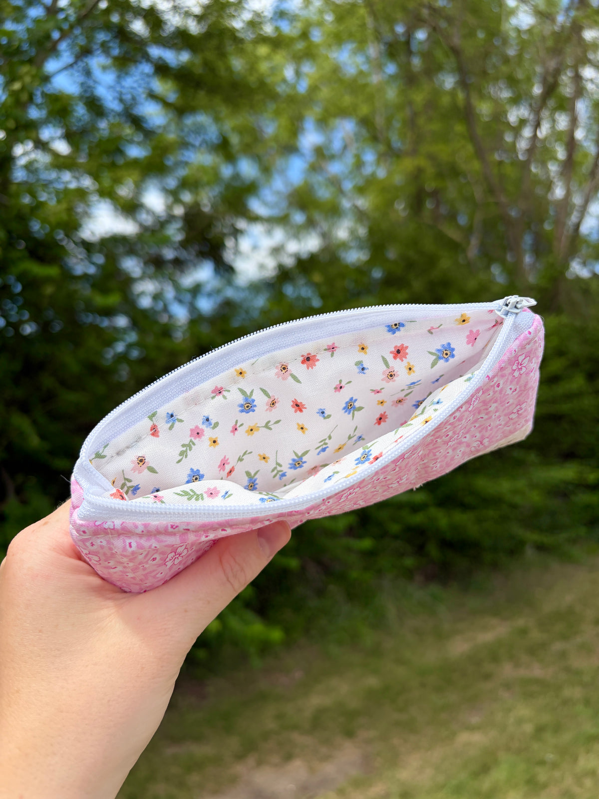 Mini pink floral pencil and glasses case opened, showing white floral lining