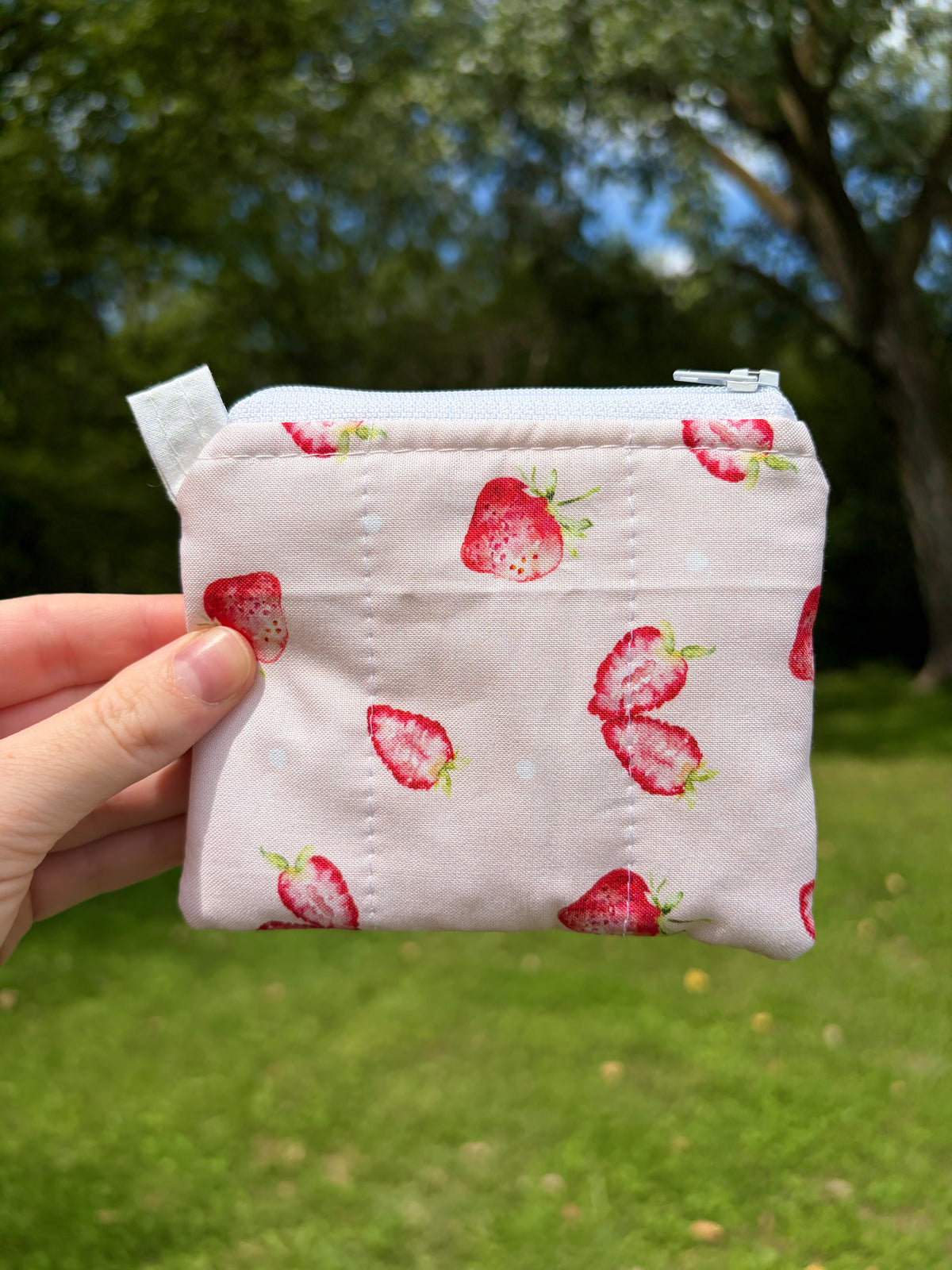 Strawberry keychain wallet with white strawberry print and top zip closure