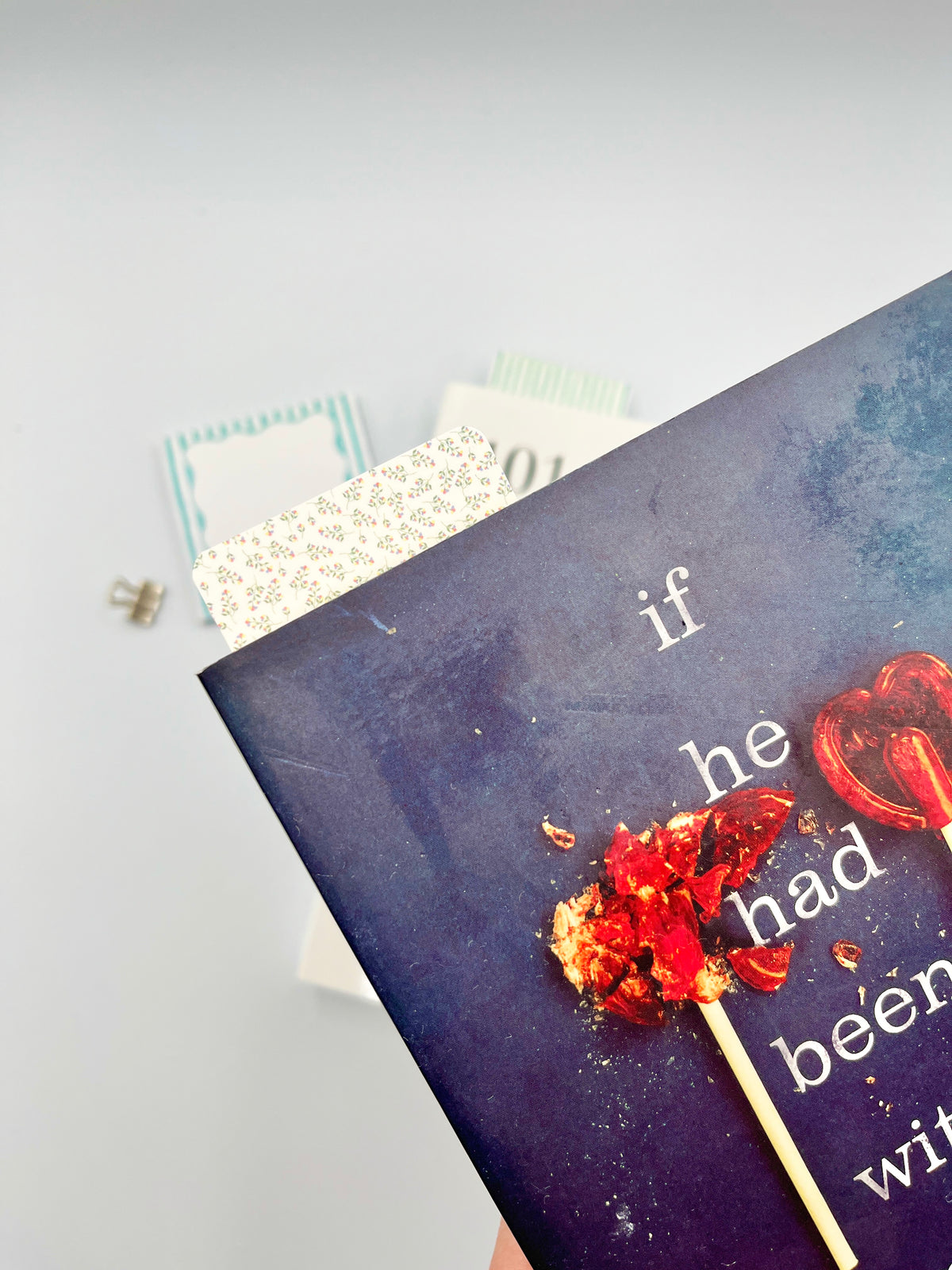 Mini floral bookmark, cream with tiny multicolor flowers, partially visible between pages
