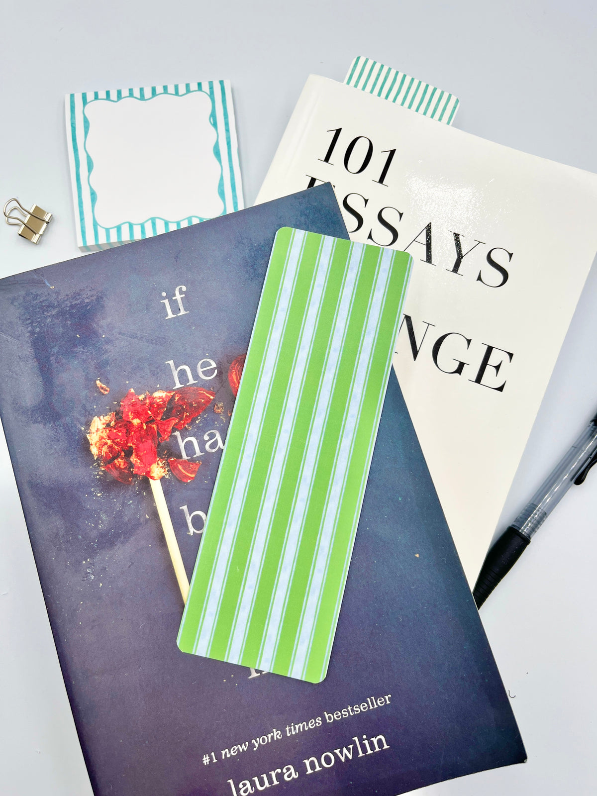 Green and white striped fabric bookmark on book pages