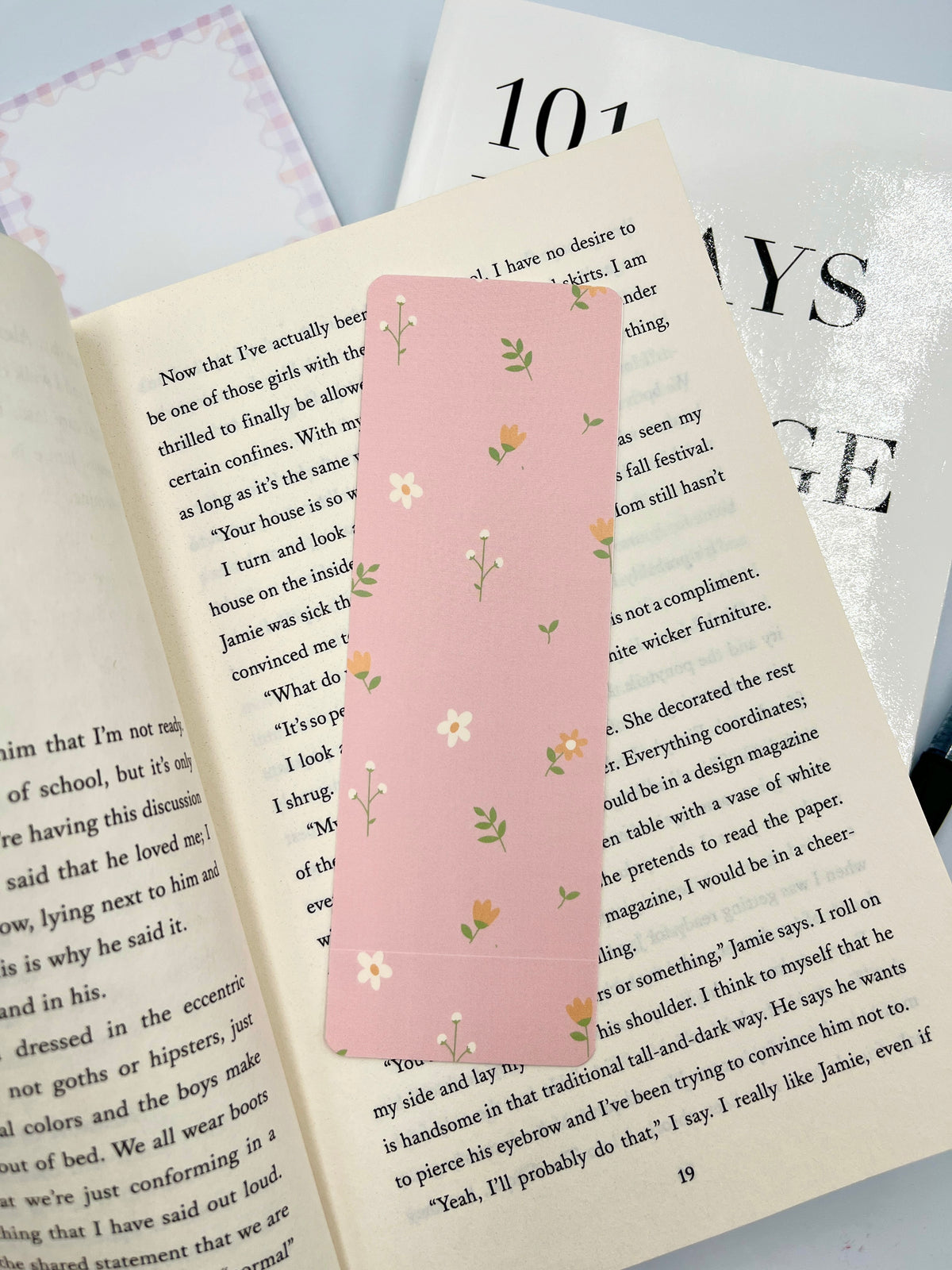 Peach floral bookmark with rounded corners, vertical pink rectangle and tiny green blossoms.