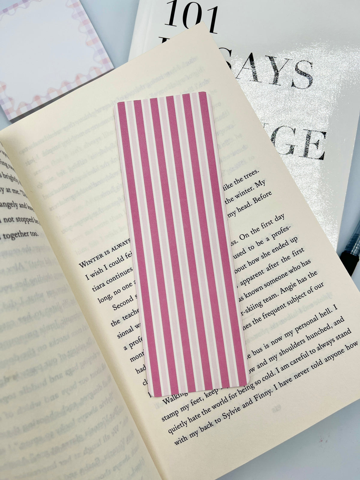 Paper bookmark with wide pink vertical stripes on white panel