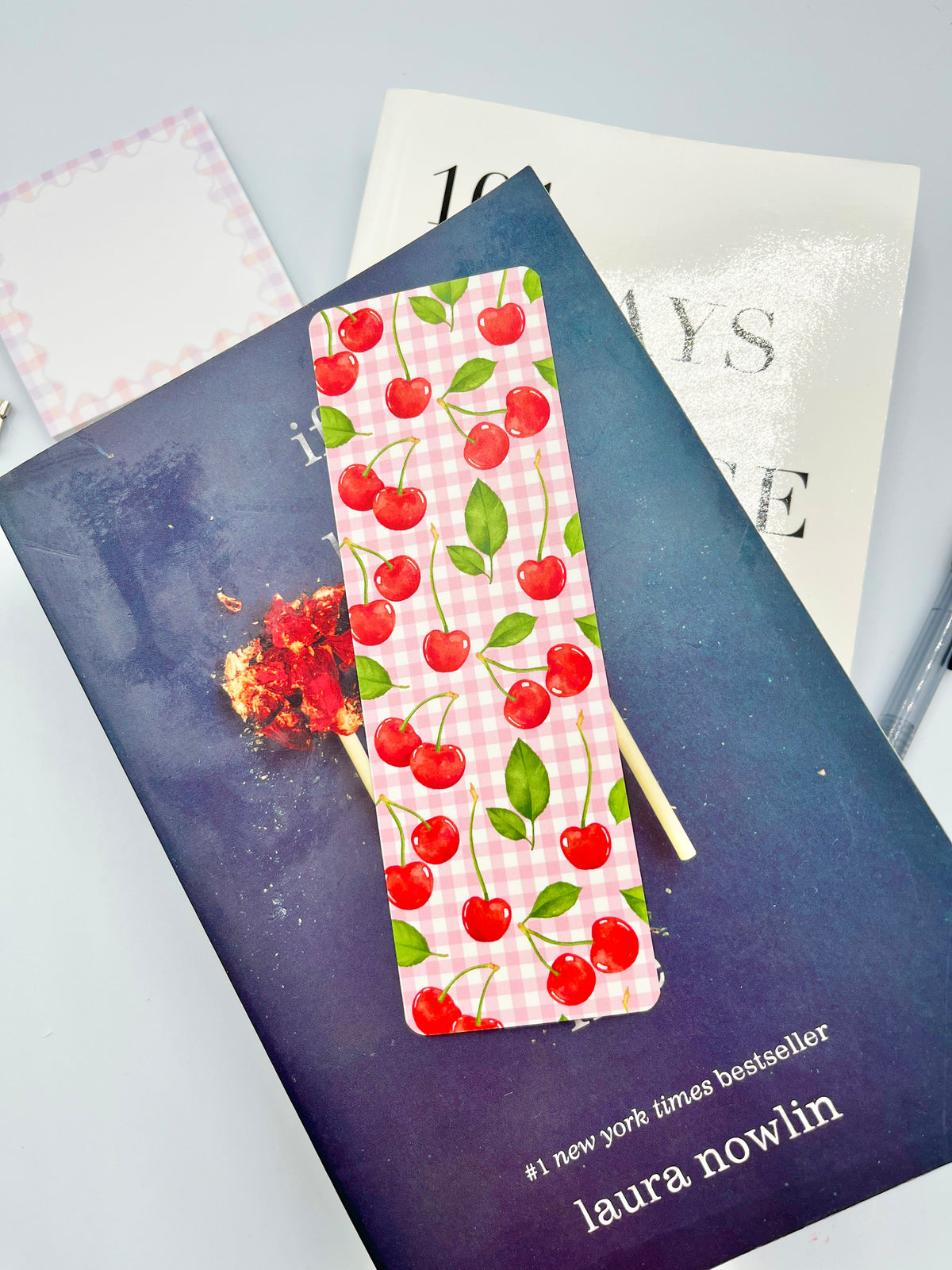 Cherry gingham bookmark with red cherries and green leaves on a pink fabric strip