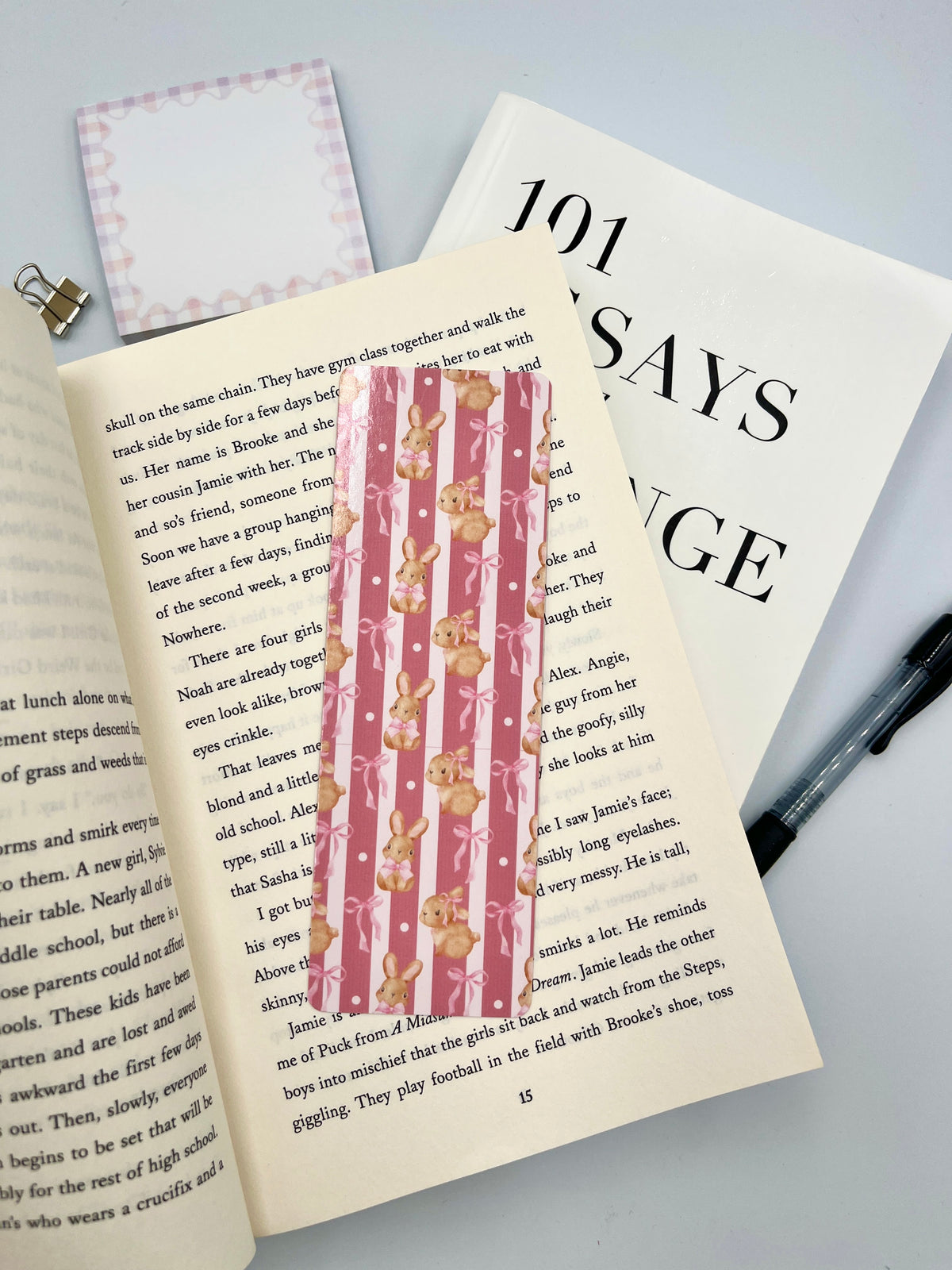 Pink vertical striped bunny bookmark shown between book pages