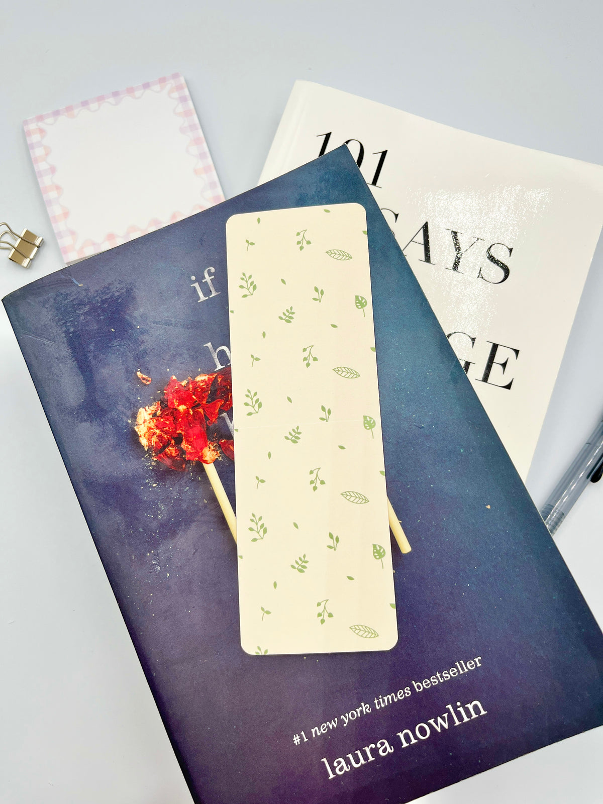 Cream bookmark with green leaf pattern, rounded top edge.