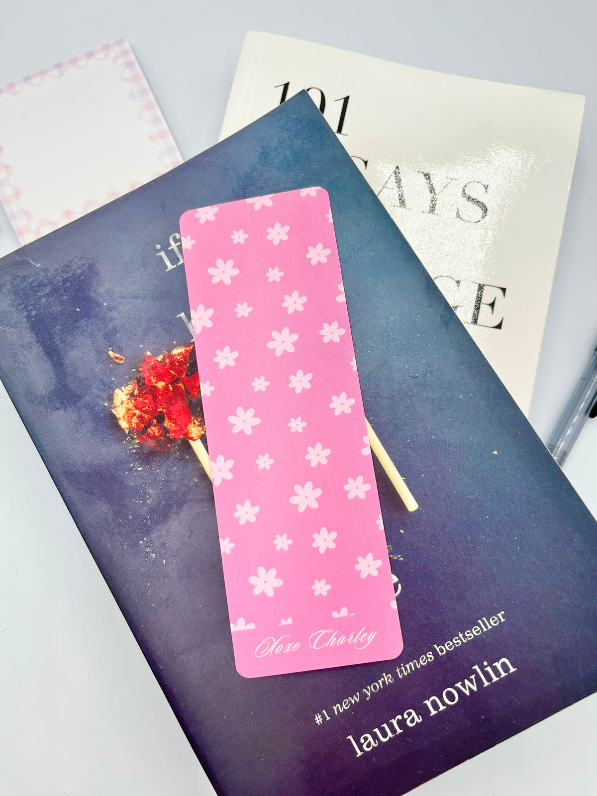 Pink floral bookmark with white flower pattern and gold tassel, Charley text