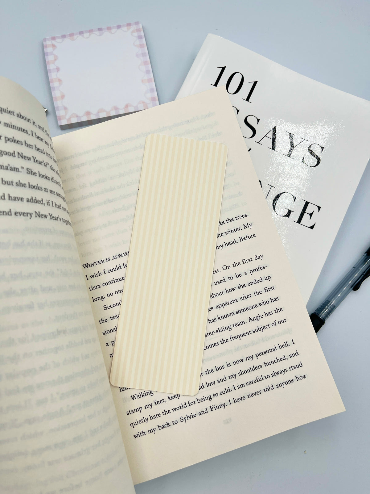 Yellow striped rectangular bookmark angled on a book page