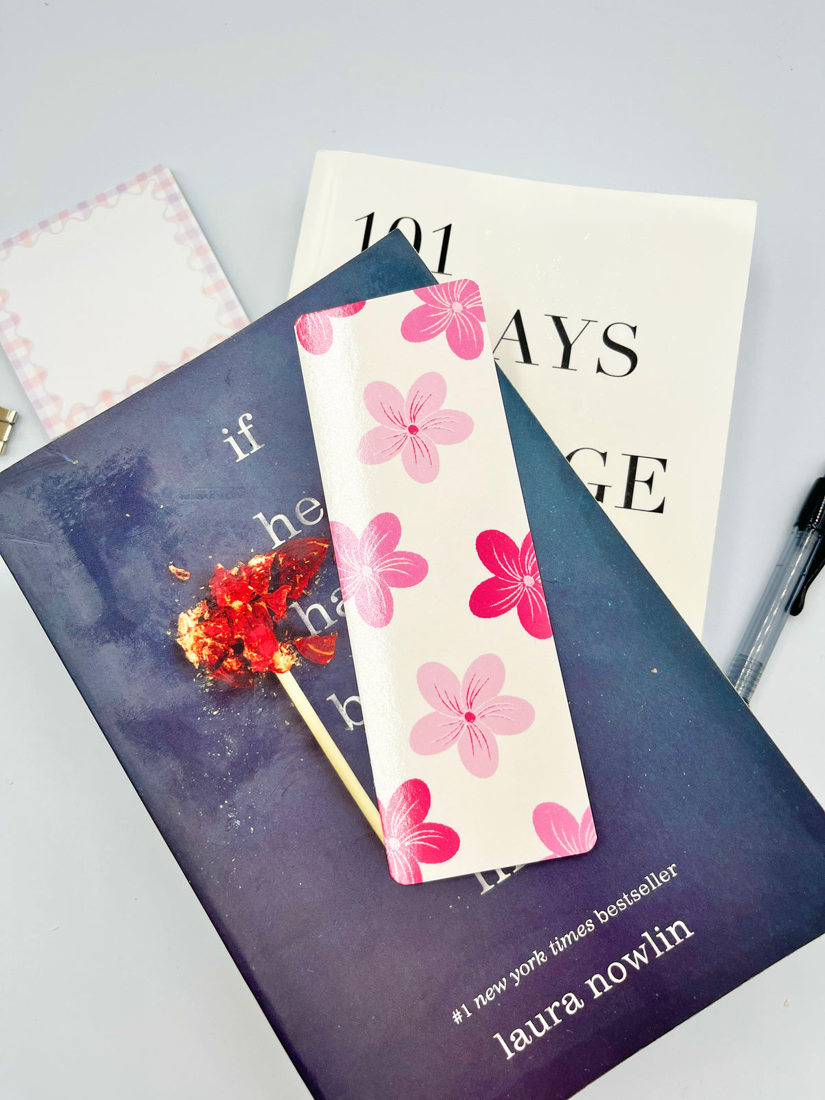 Pink floral fabric bookmark with pink flowers on a light background, rectangular shape