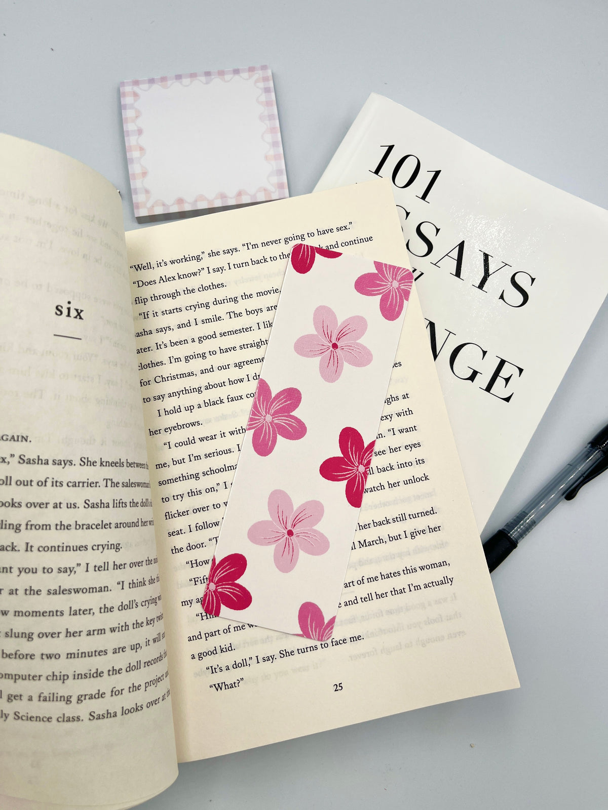 Pink flower bookmark, rectangular with scattered pink blossoms on white background