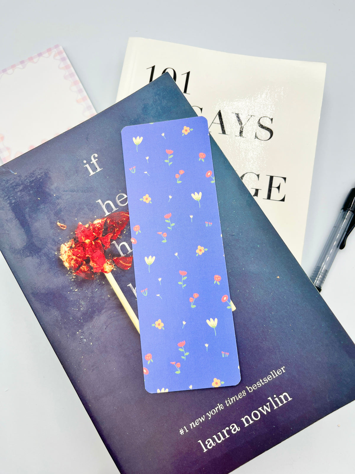 Floral bookmark with blue background and multicolor tiny flower pattern, metal loop