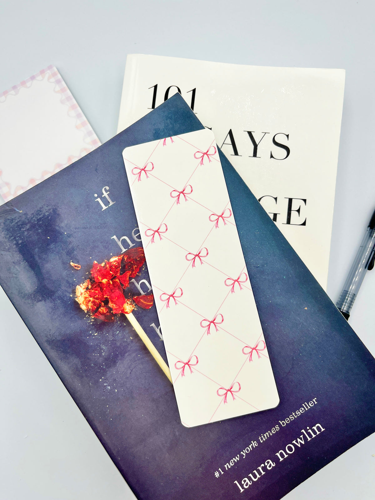 Pink bow bookmark with five pink ribbon bows on a white paper strip