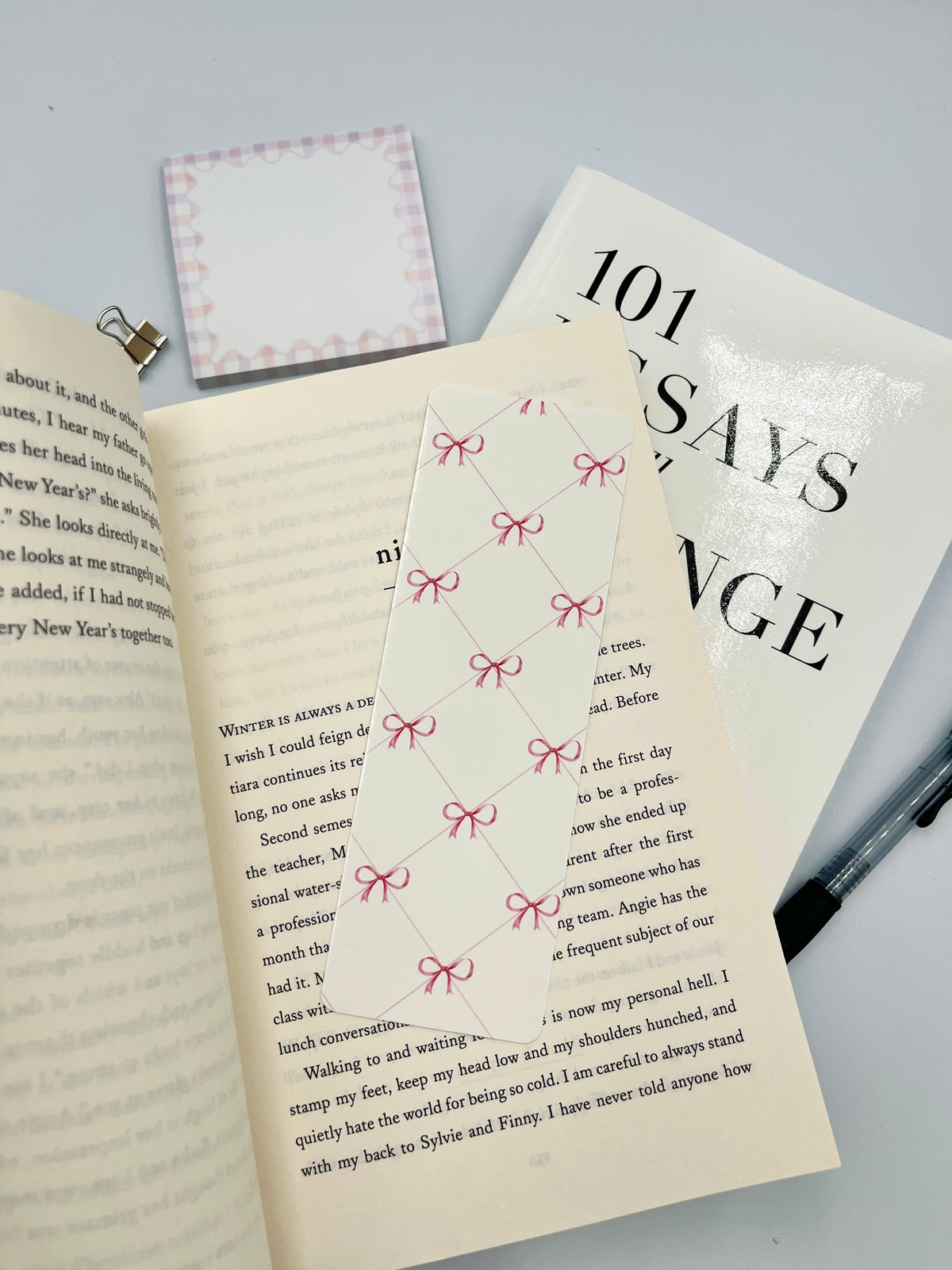 Pink bow bookmark with repeating bow pattern on a white paper strip