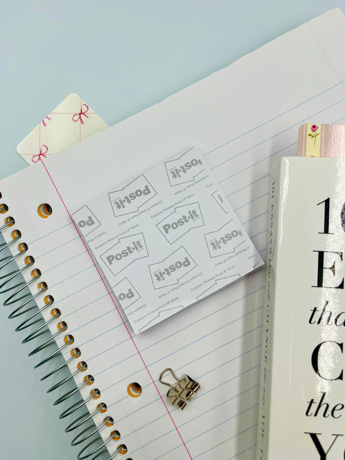 Pastel gingham sticky note pads with pink gingham border, stacked on planner