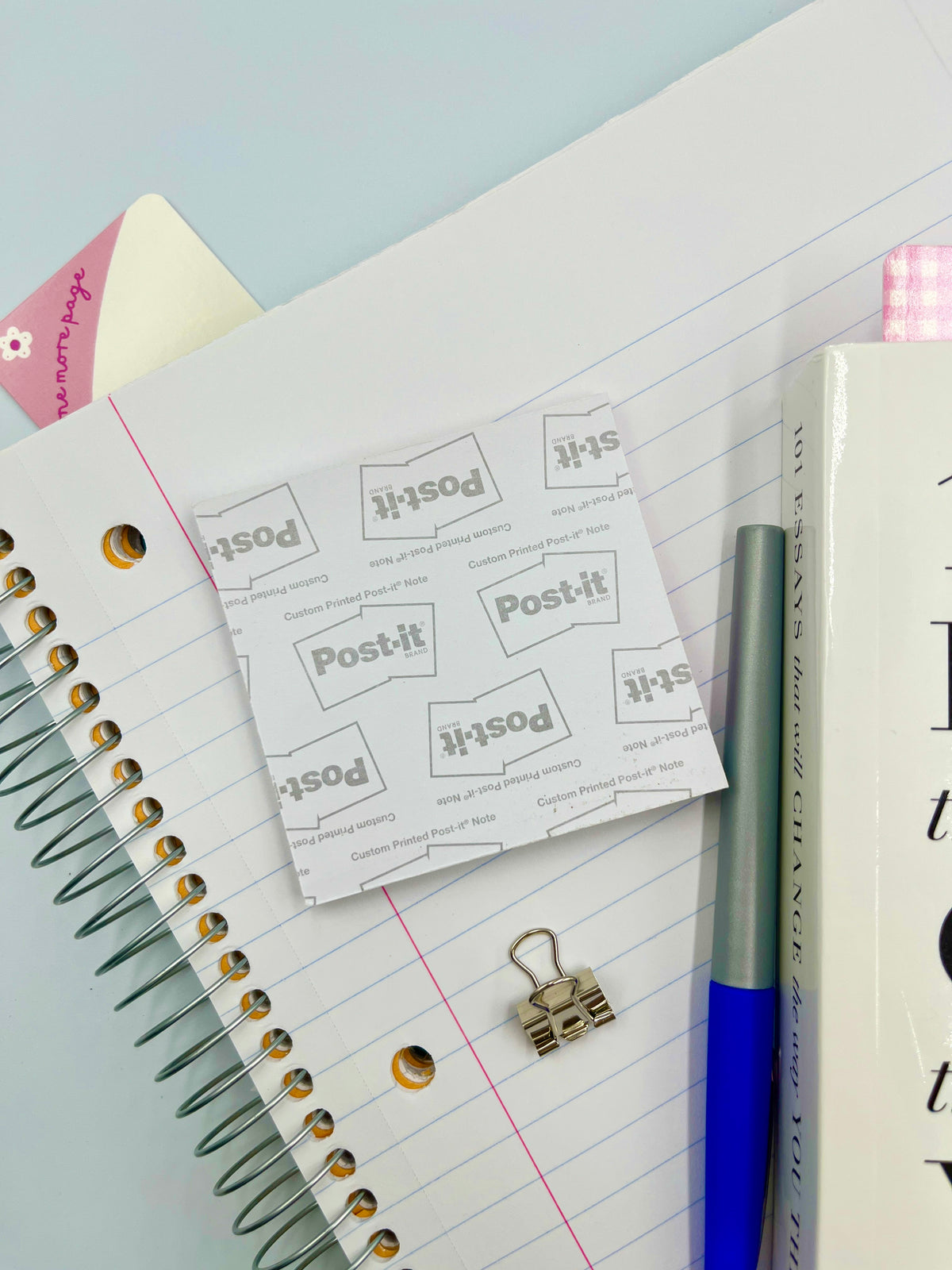 Post-it sticky notes with pink flower icons, on lined notebook page