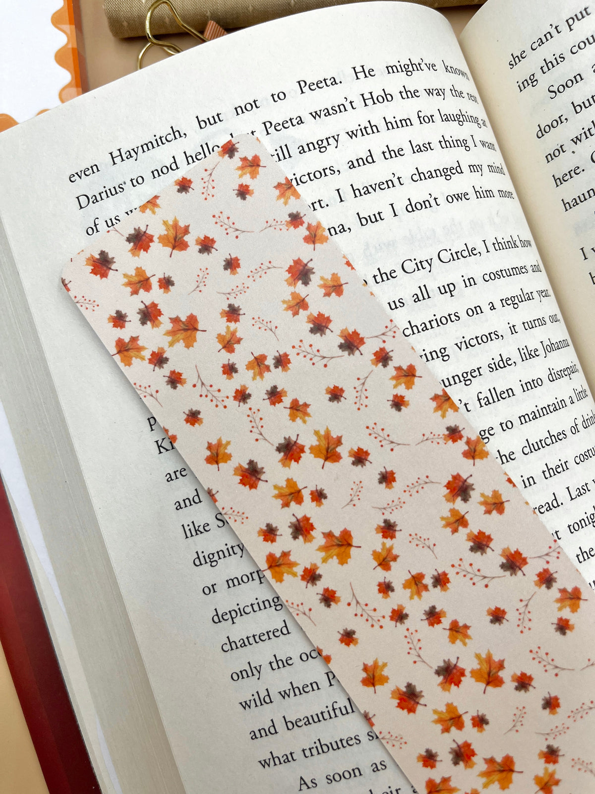 Autumn leaves bookmark with scattered orange leaf motifs on a white book page