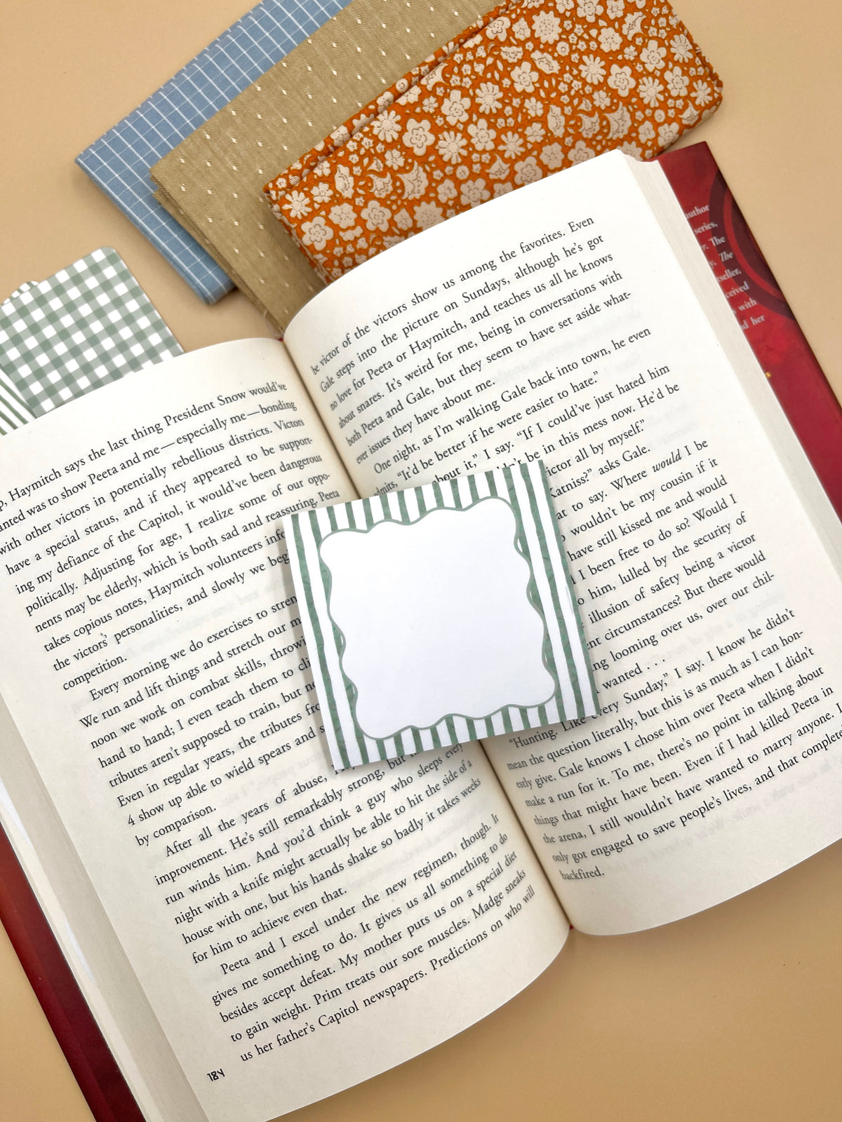 Set of green striped sticky notes shaped like labels on open notebook pages