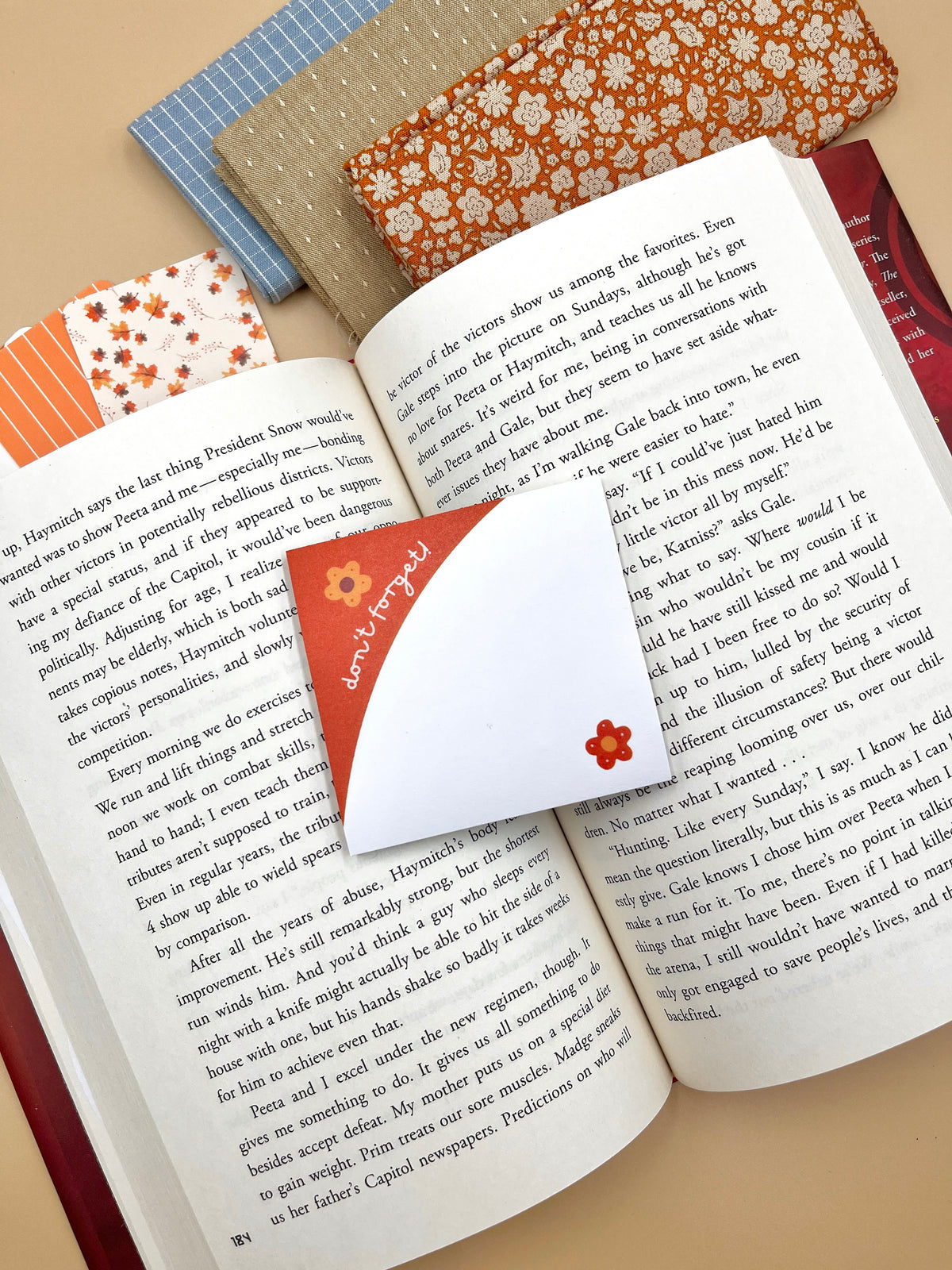 Orange floral sticky notes tabs on open book pages