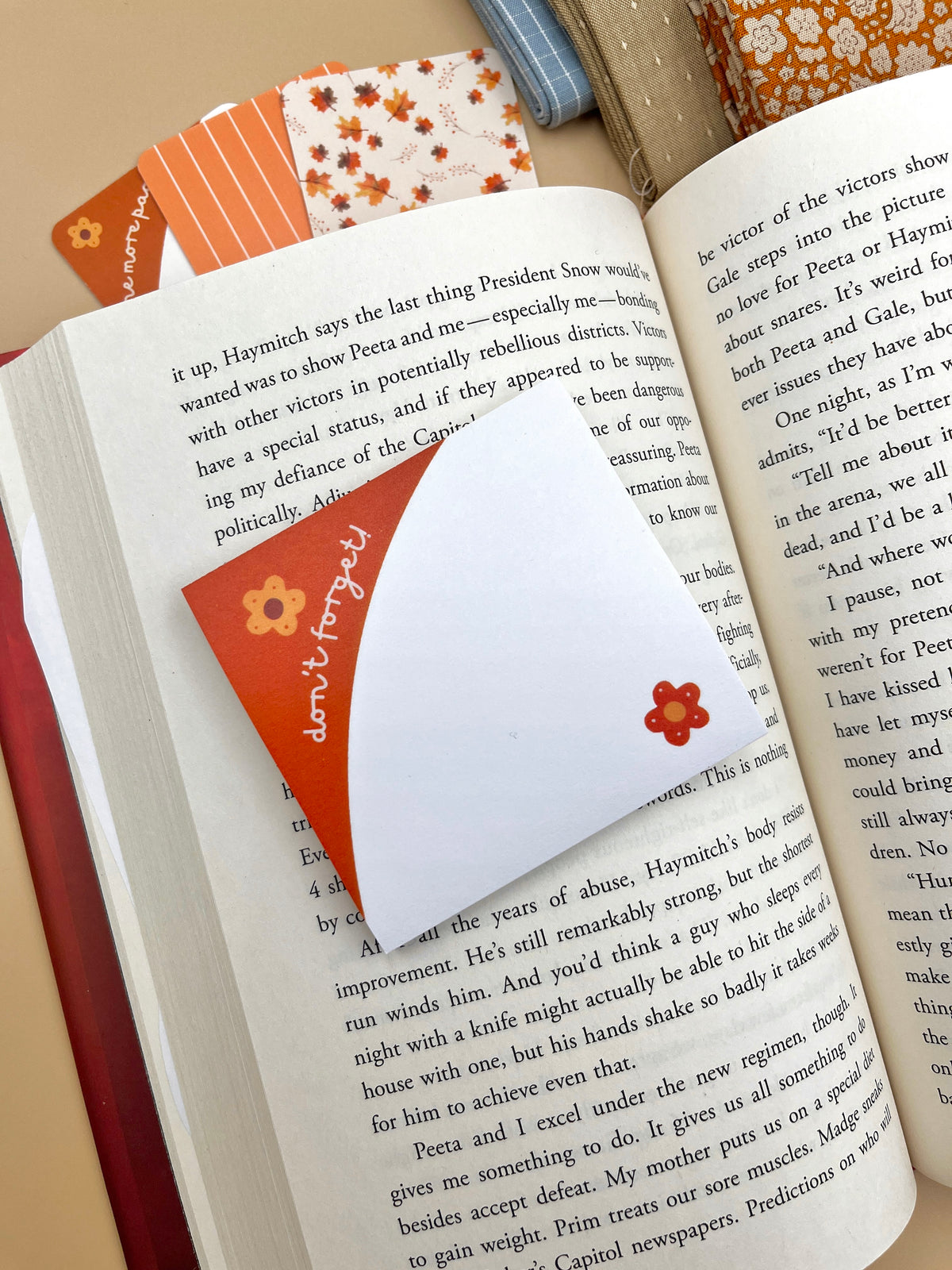 Orange-and-white floral sticky notes on open book pages