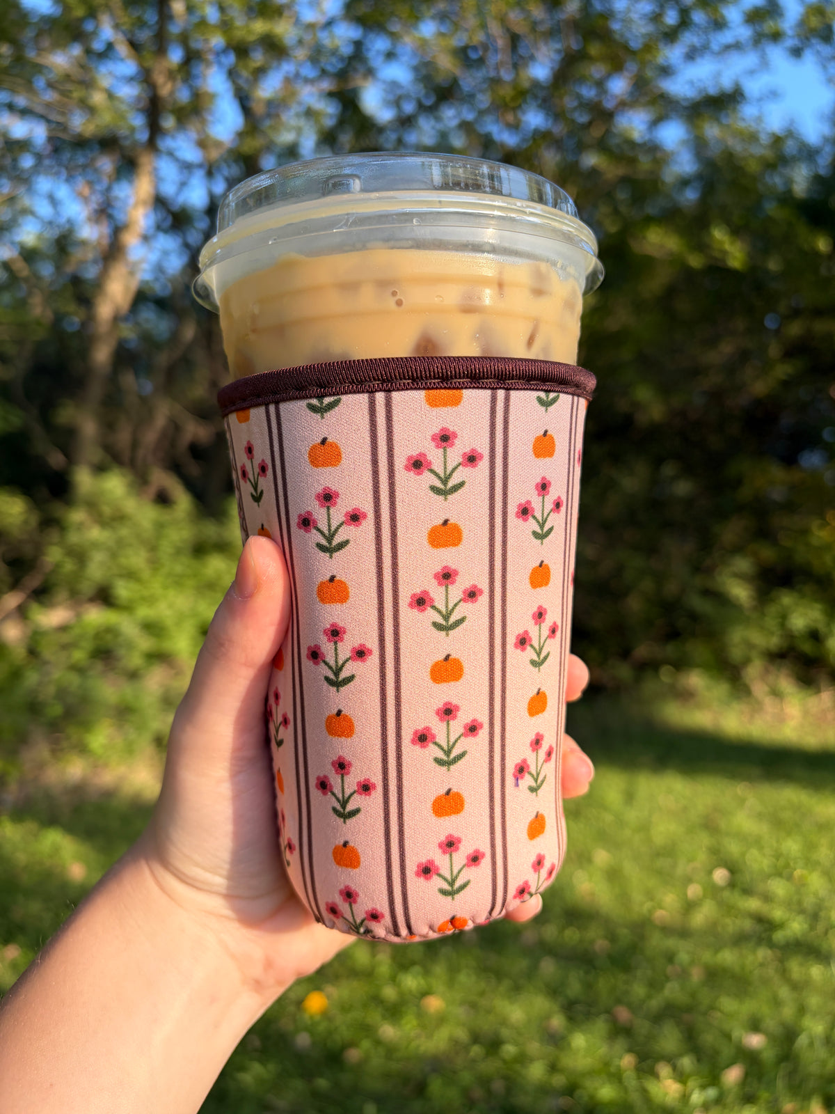 Medium pumpkin patch cup sleeve, pink fabric with orange pumpkins and red floral sprigs.