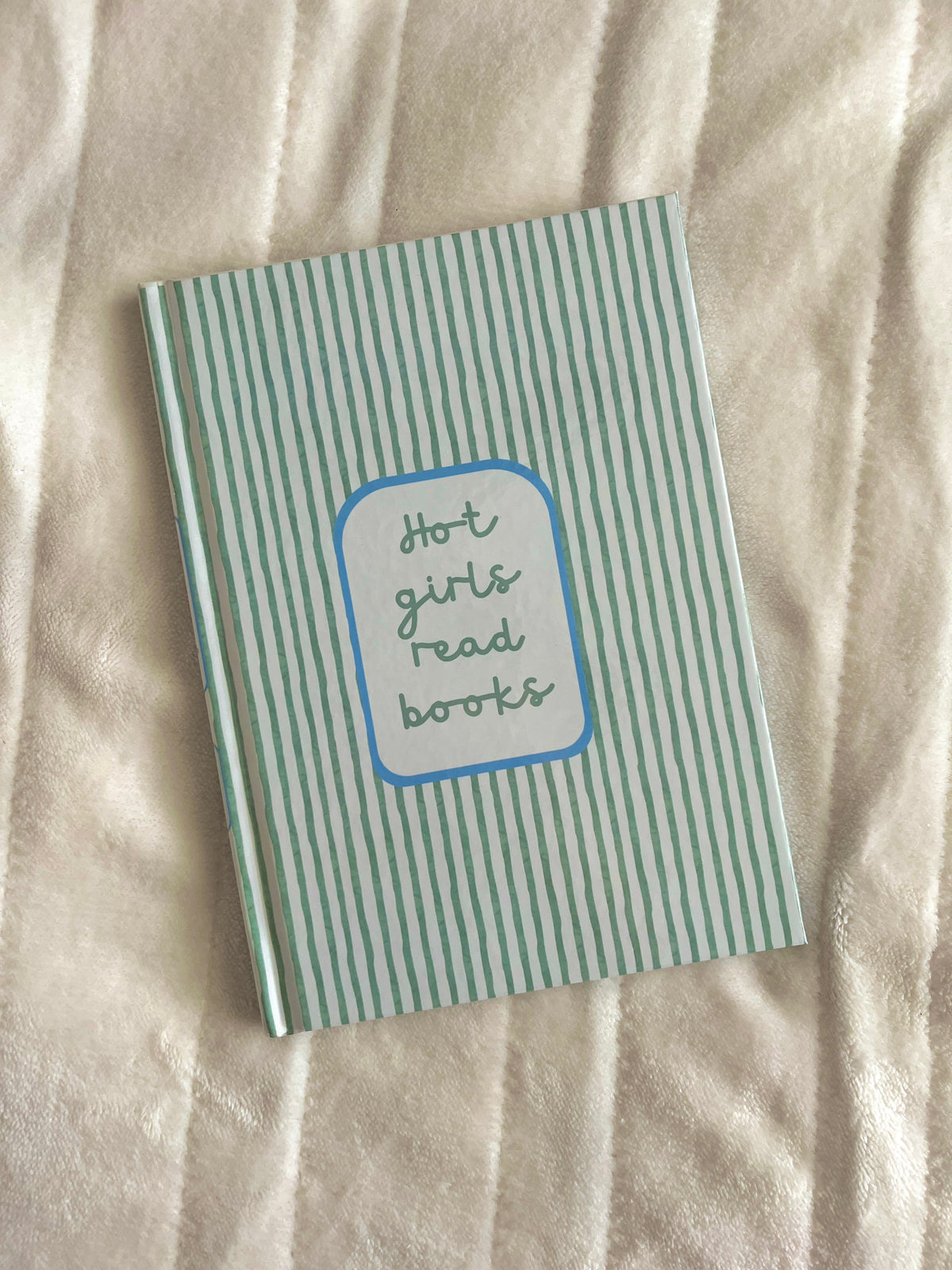 Green striped journal cover with blue "Hot girls read books" badge