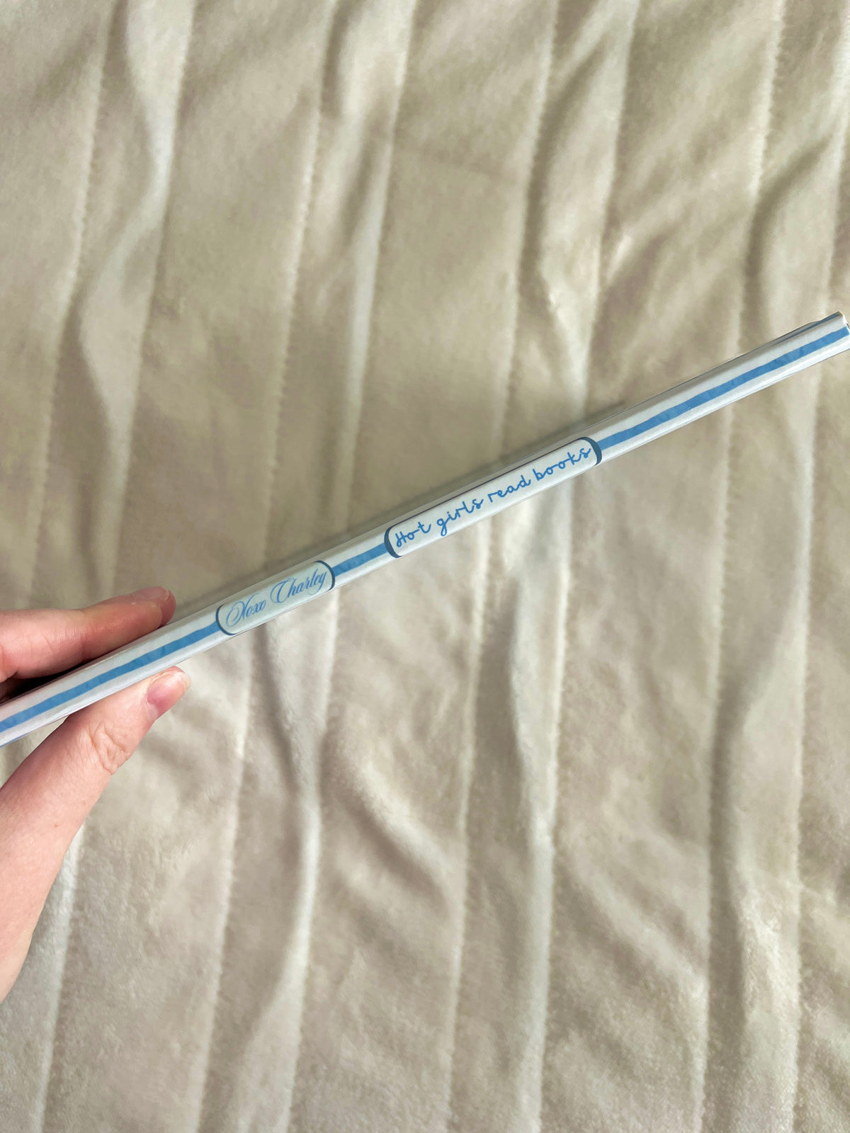 Blue striped journal edge with 'hot girls read books' printed along the side