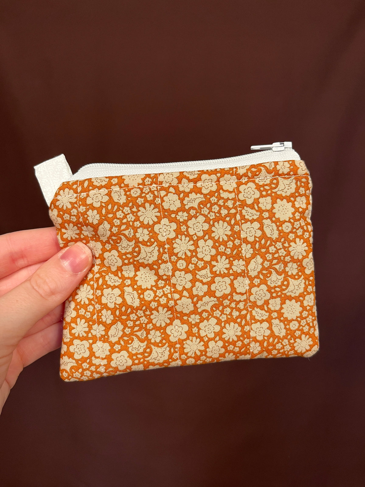 Orange floral keychain wallet with metal key ring and white zipper