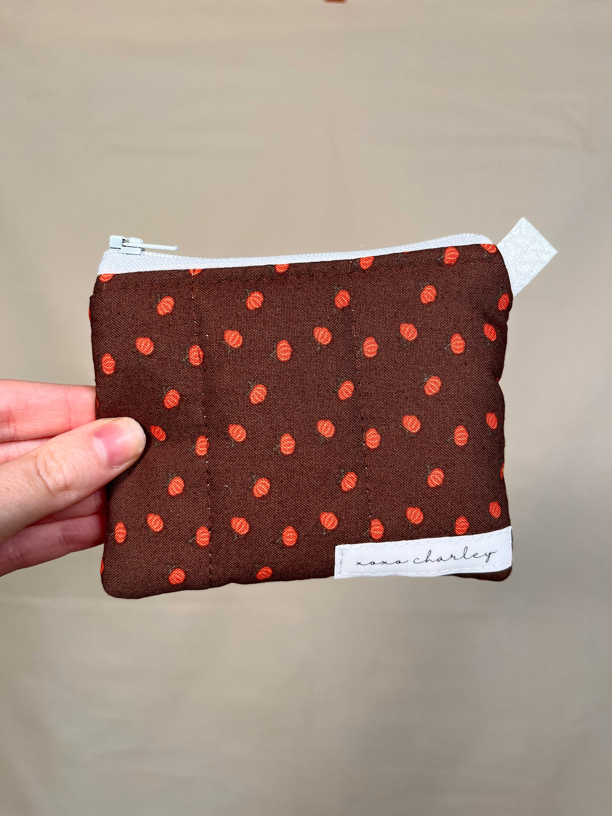 Mini pumpkin keychain wallet, dark brown with orange pattern, zip-top pouch
