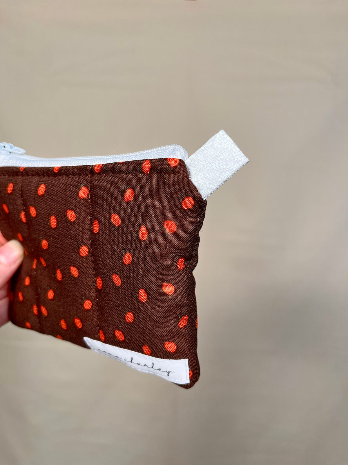 Mini pumpkin keychain wallet, dark brown zip pouch with orange pumpkin pattern