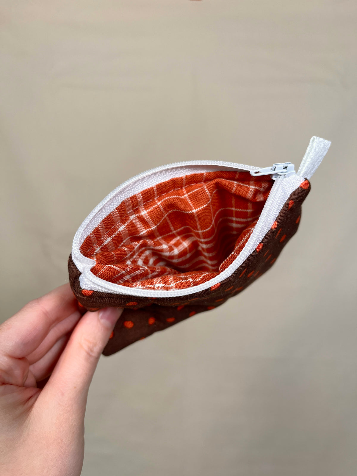 Mini pumpkin keychain wallet interior, red plaid lining with zip closure