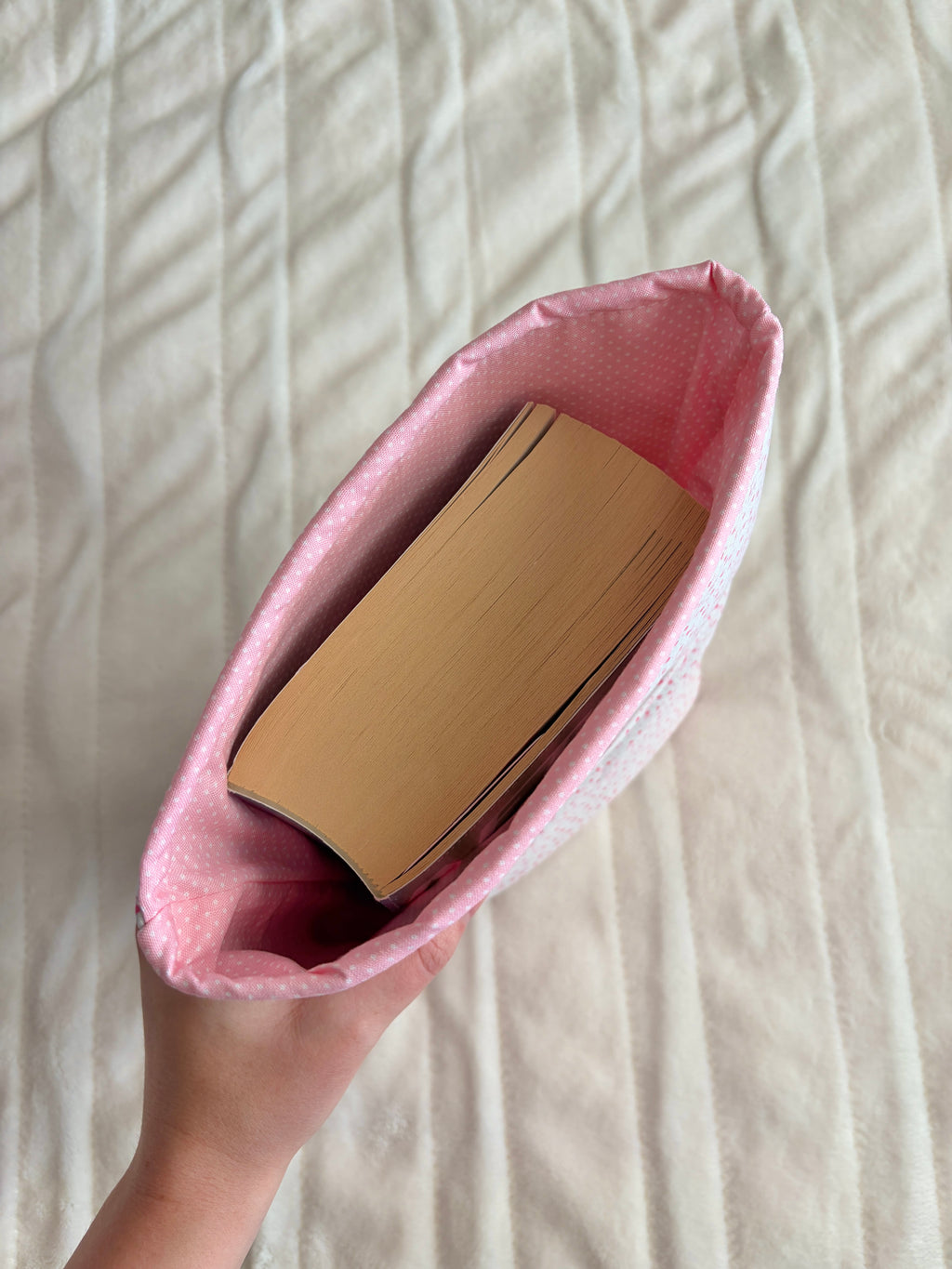 Heart-print Bible sleeve with pink lining, holding a book inside.