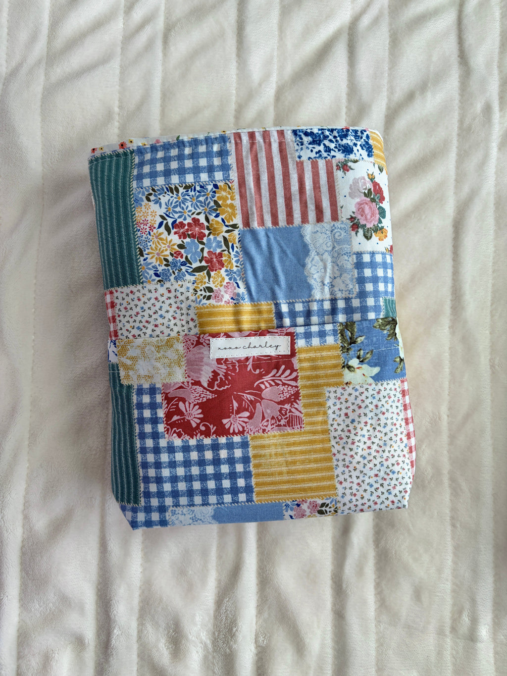 Patchwork Bible sleeve with blue, red, yellow, and white fabric panels