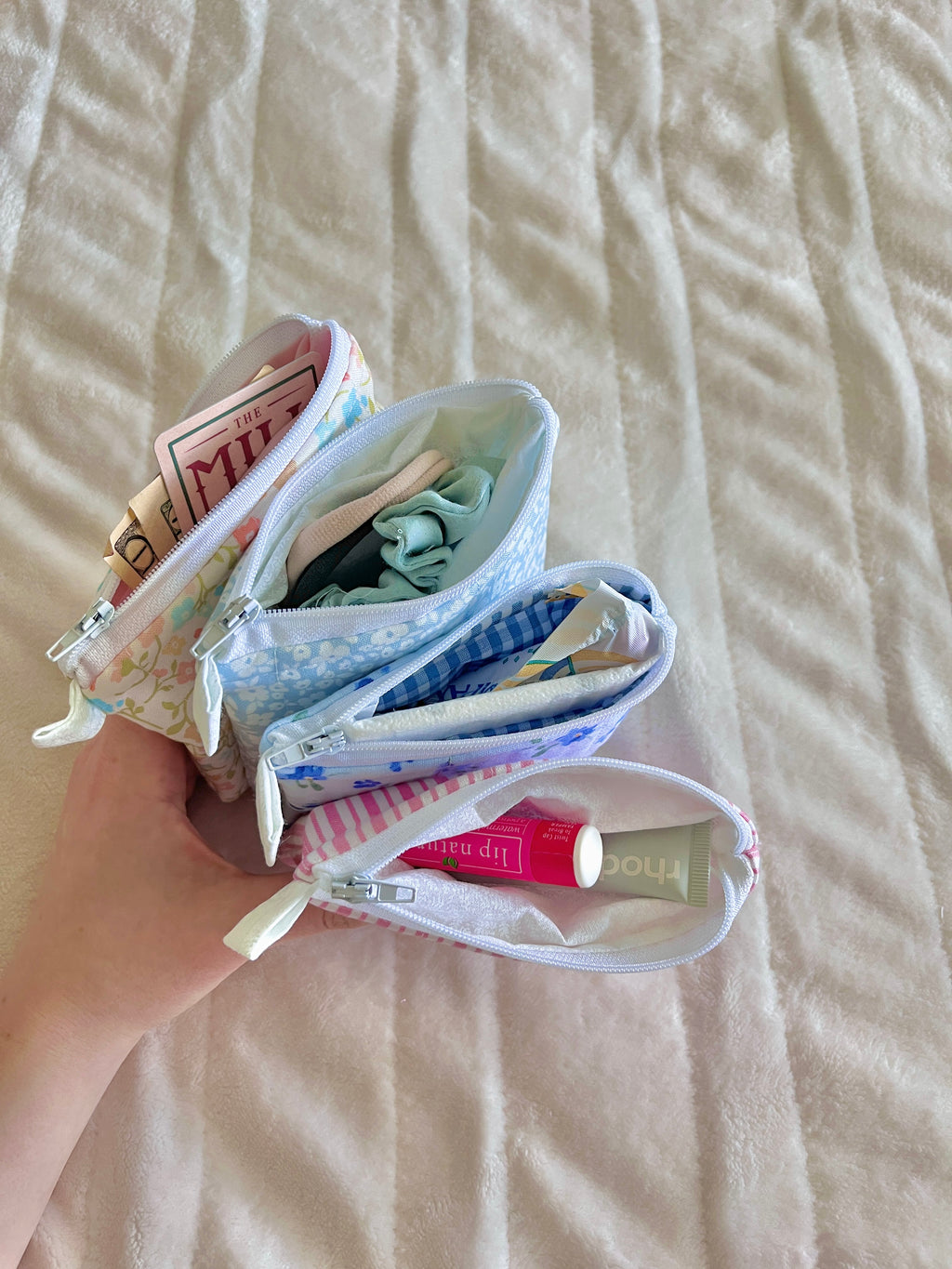 Floral keychain wallet pouch, open view with small items inside